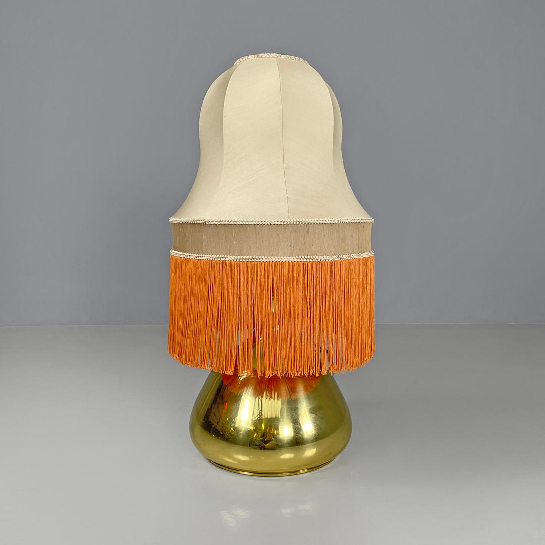 Late 20th Century Italian brass table lamp with beige lampshade and orange fringes, 1980s For Sale
