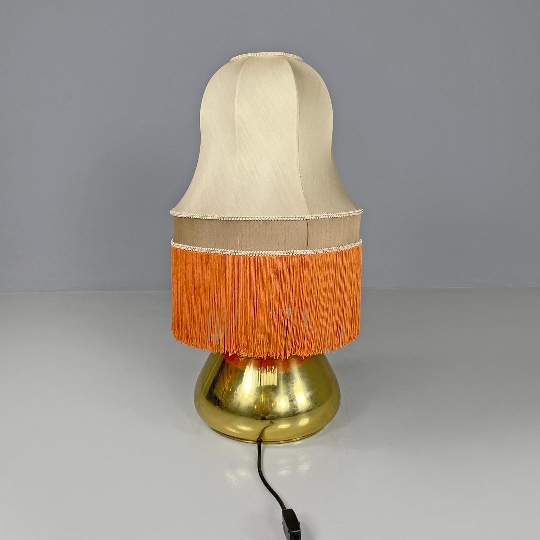 Metal Italian brass table lamp with beige lampshade and orange fringes, 1980s For Sale
