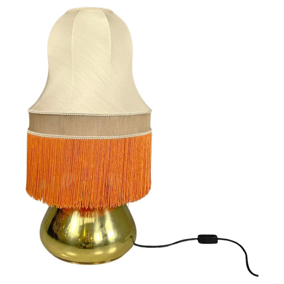 Italian brass table lamp with beige lampshade and orange fringes, 1980s For Sale