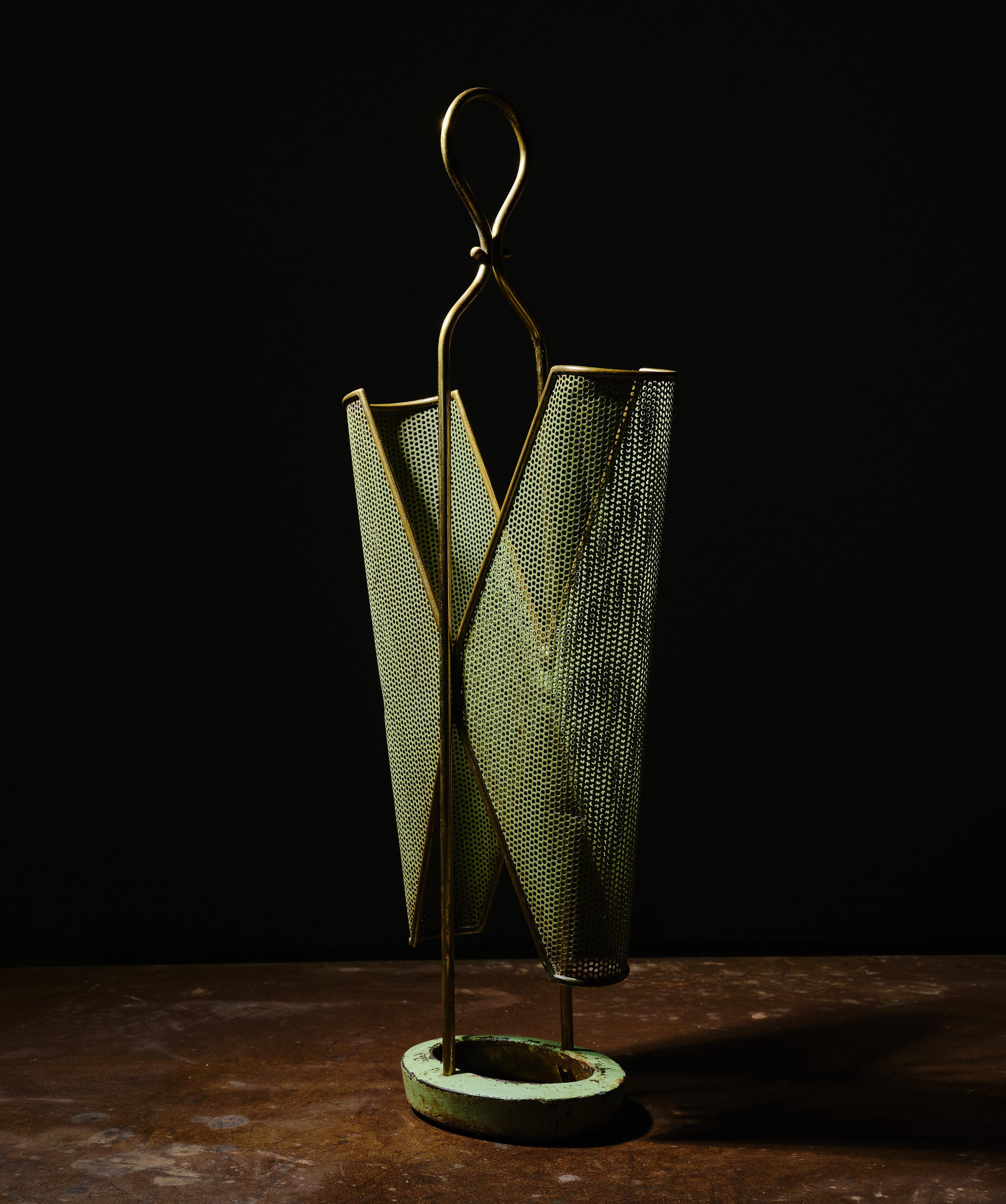 An elegant brass umbrella stand with sage green enamelled parts, designed and produced in Italy in the 1950s.

The brass shows evident and pleasant signs of aging, there are also small lacks in the green enamelled parts.