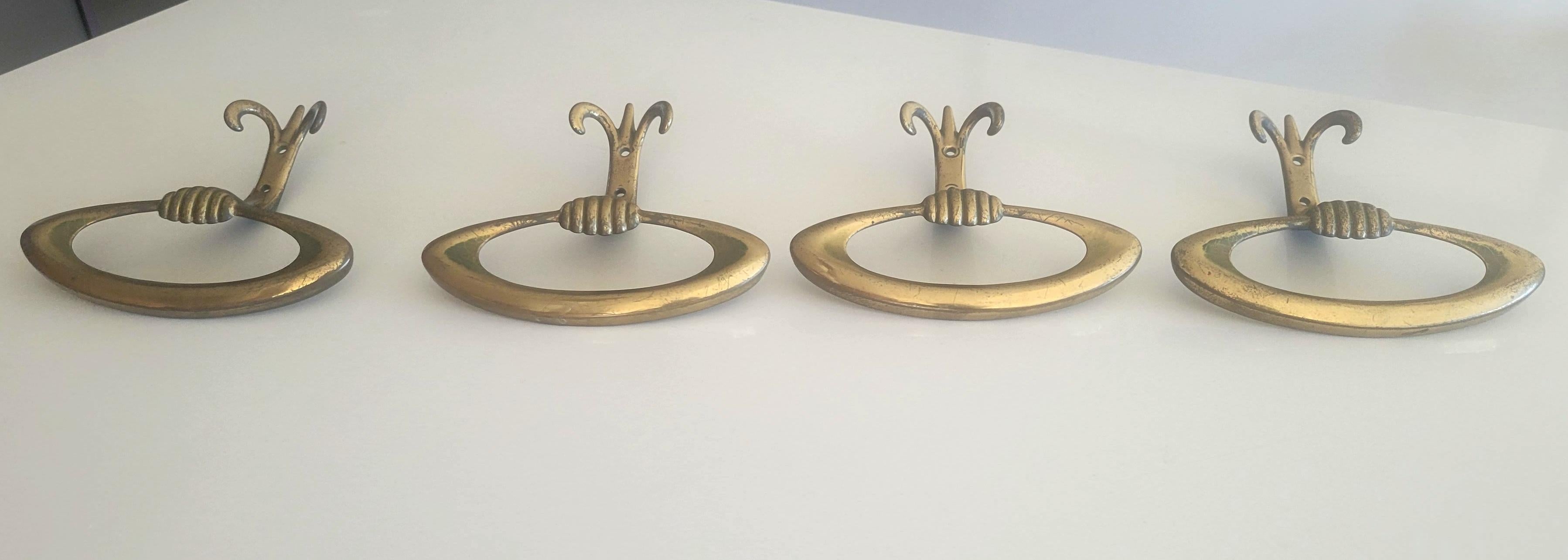 Four Italian brass wall hooks 
Original from the period.
