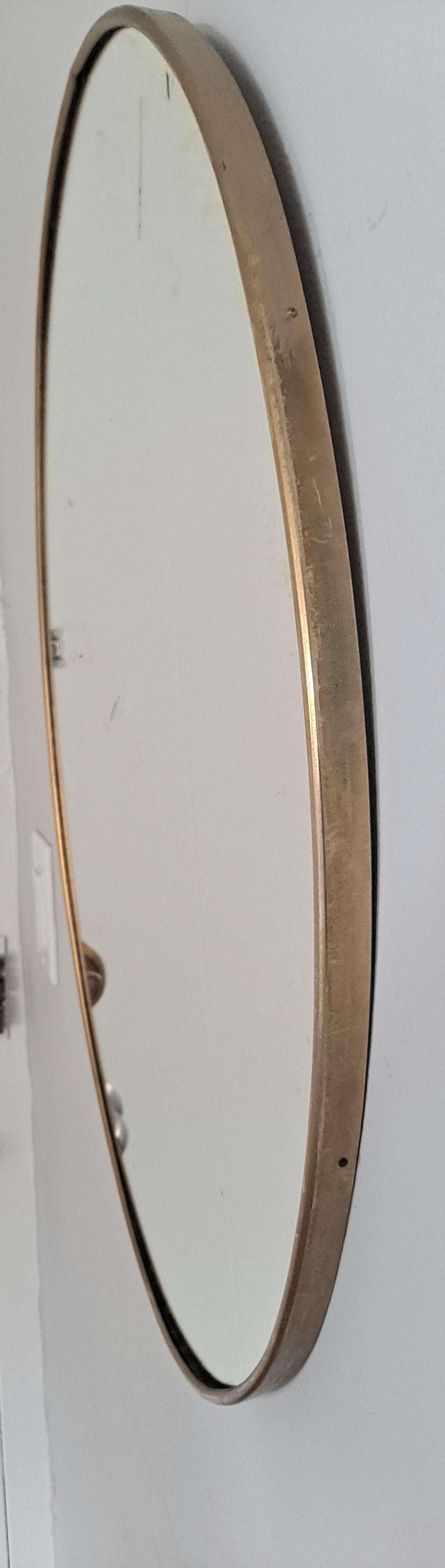 Wall brass mirror on the wood backing.