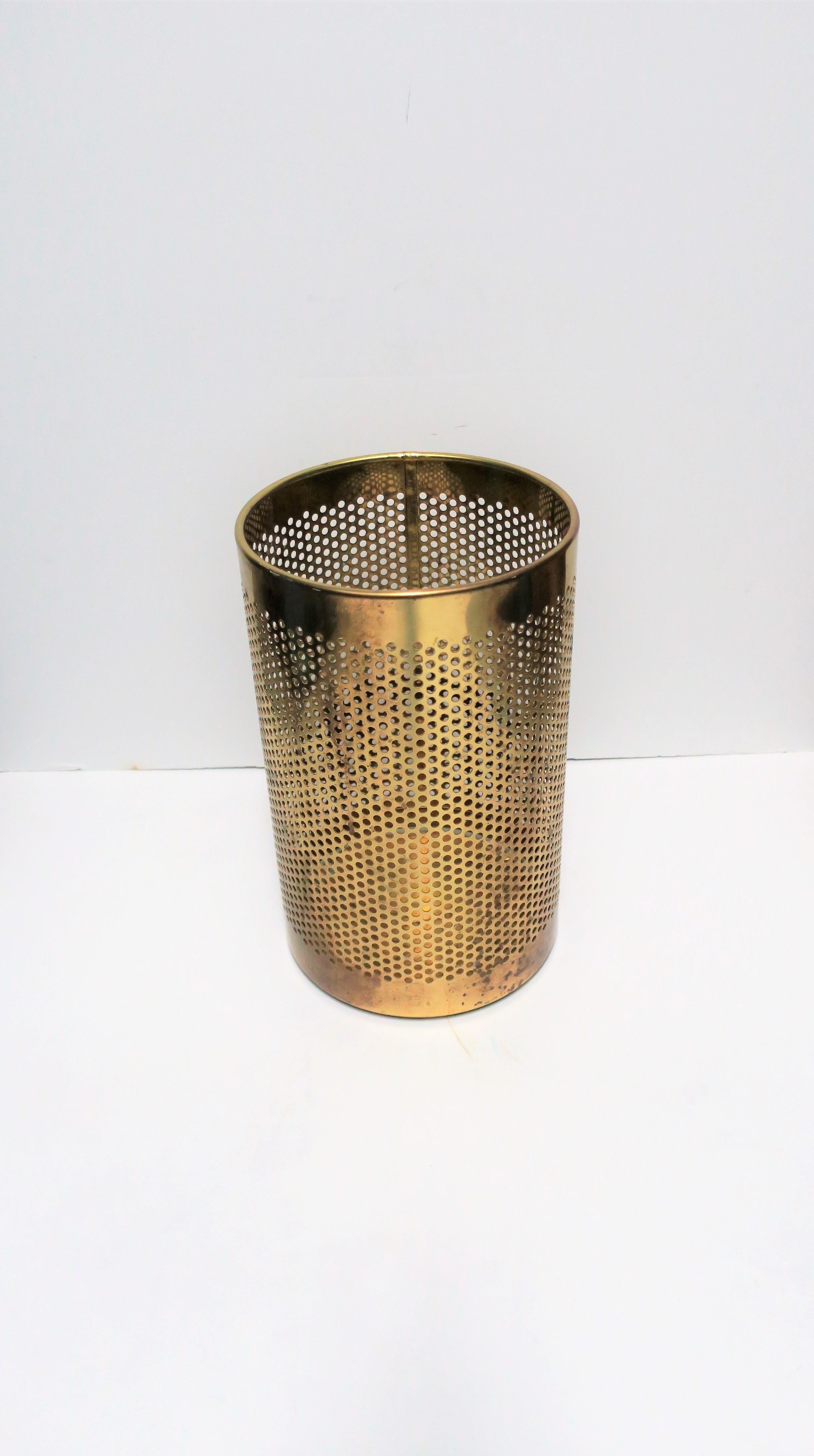 A beautiful vintage Italian brass perforated wastebasket or trash can, marked made in Italy on bottom as show in image #4, circa late 20th century, Italy. This round brass waste basket's design is comprised of small round perforated circles.
