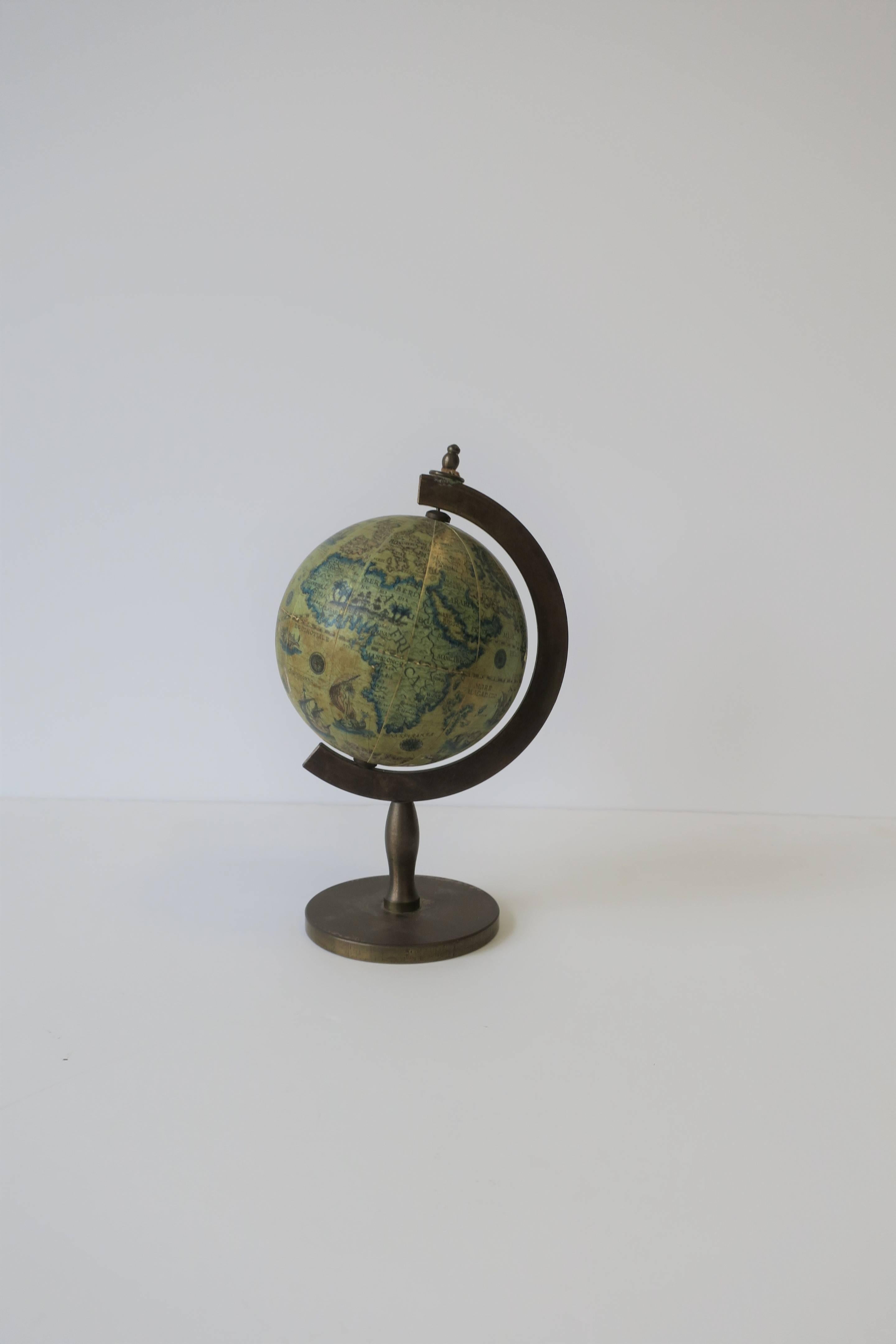 An Italian Midcentury small world globe that spins. Hardware is brass. Marked 