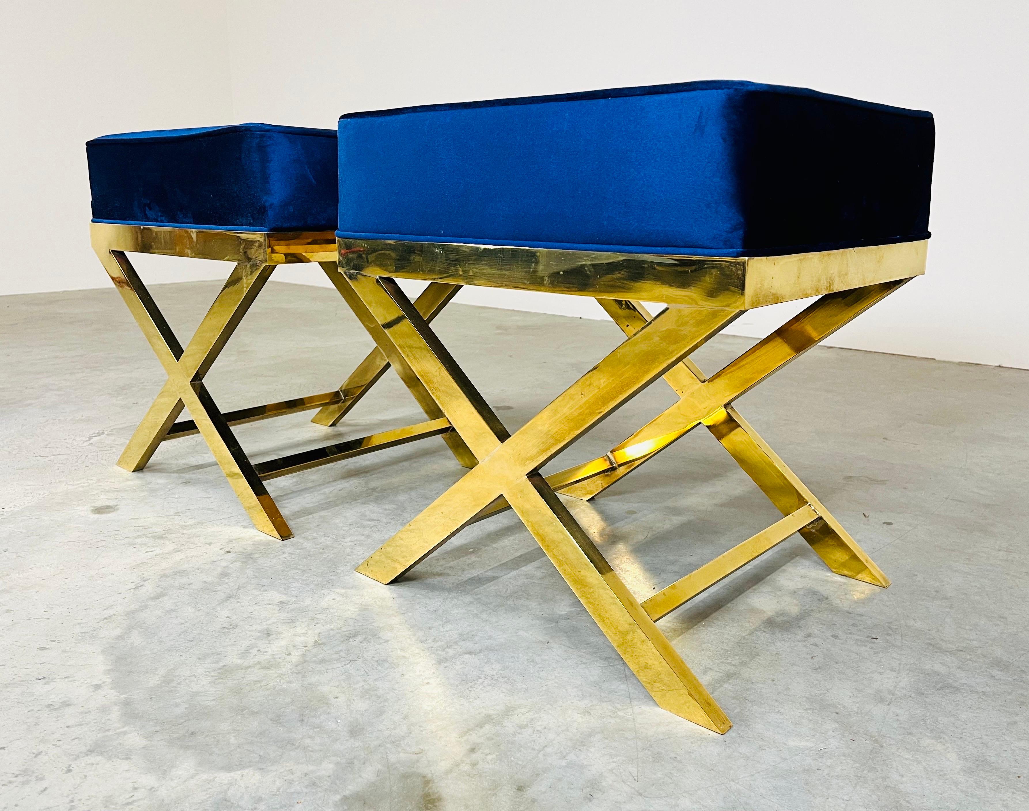 Fully restored solid flat bar brass pair of X benches or stools in the manner of Charles Hollis Jones. 1960's Italy polished brass with new plush deep blue velvet cushions each possessing substantial weight.
21.25x20.25x16.25” HWD.
