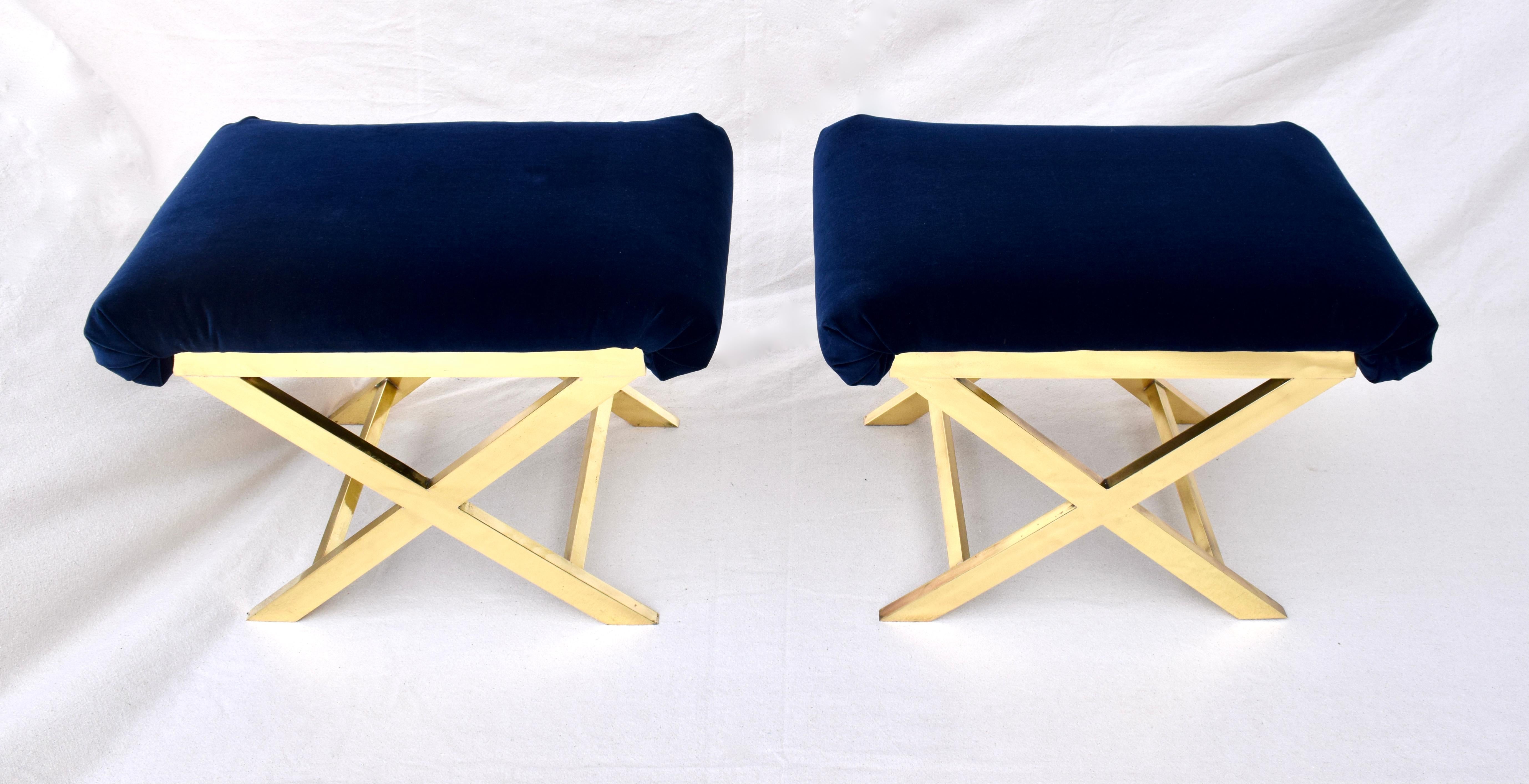 Fully restored solid flat bar brass pair of X benches or stools in the manner of Charles Hollis Jones. 1960's Italy polished brass with new plush deep blue velvet cushions each possessing substantial weight.