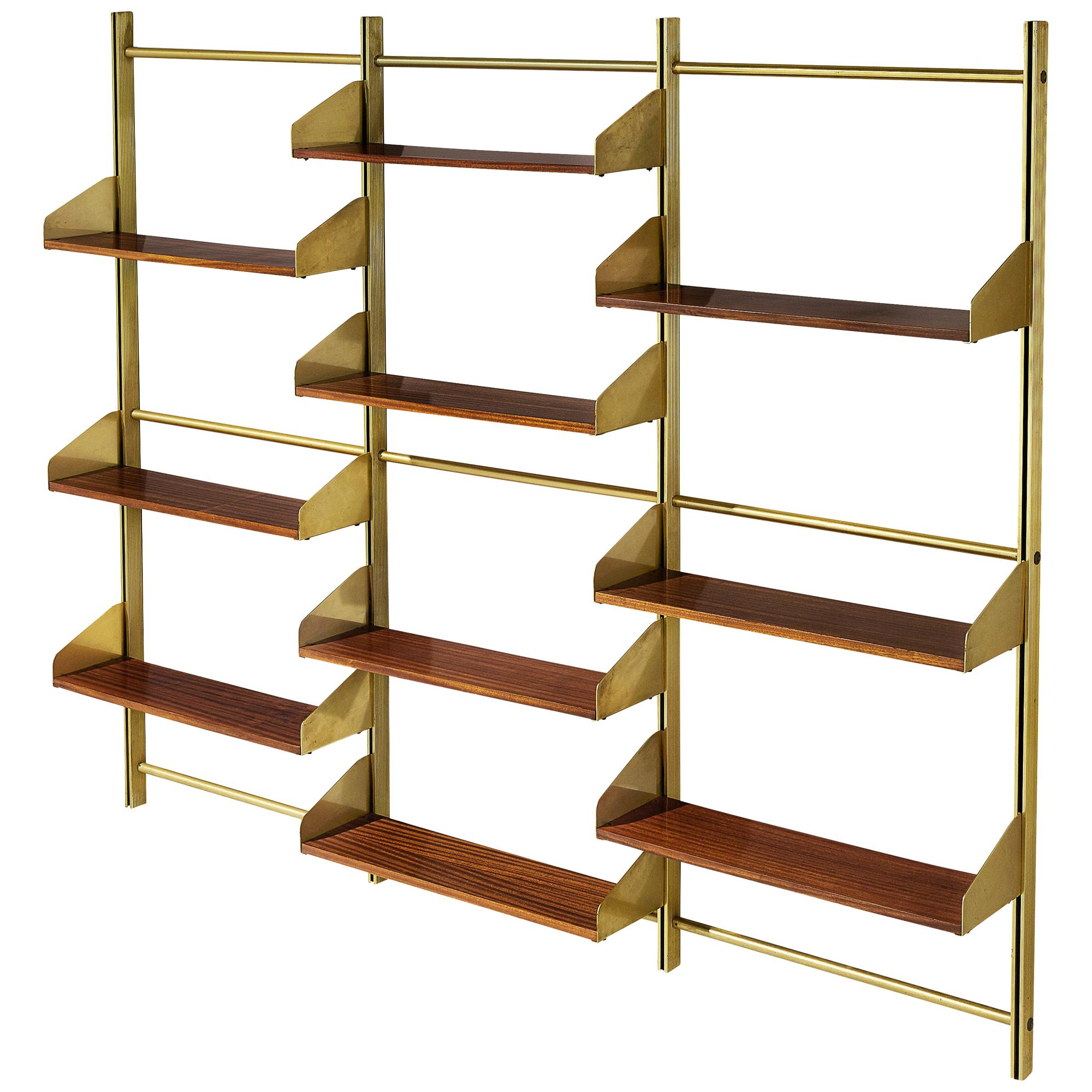 Feal, wall unit, teak, brass and brassed aluminum, Italy, 1950s

This eloquent wall unit from Italy is made with a brassed aluminum frame, connective joints and plenty of teak shelves. Three columns structure the shelf vertically. The combination
