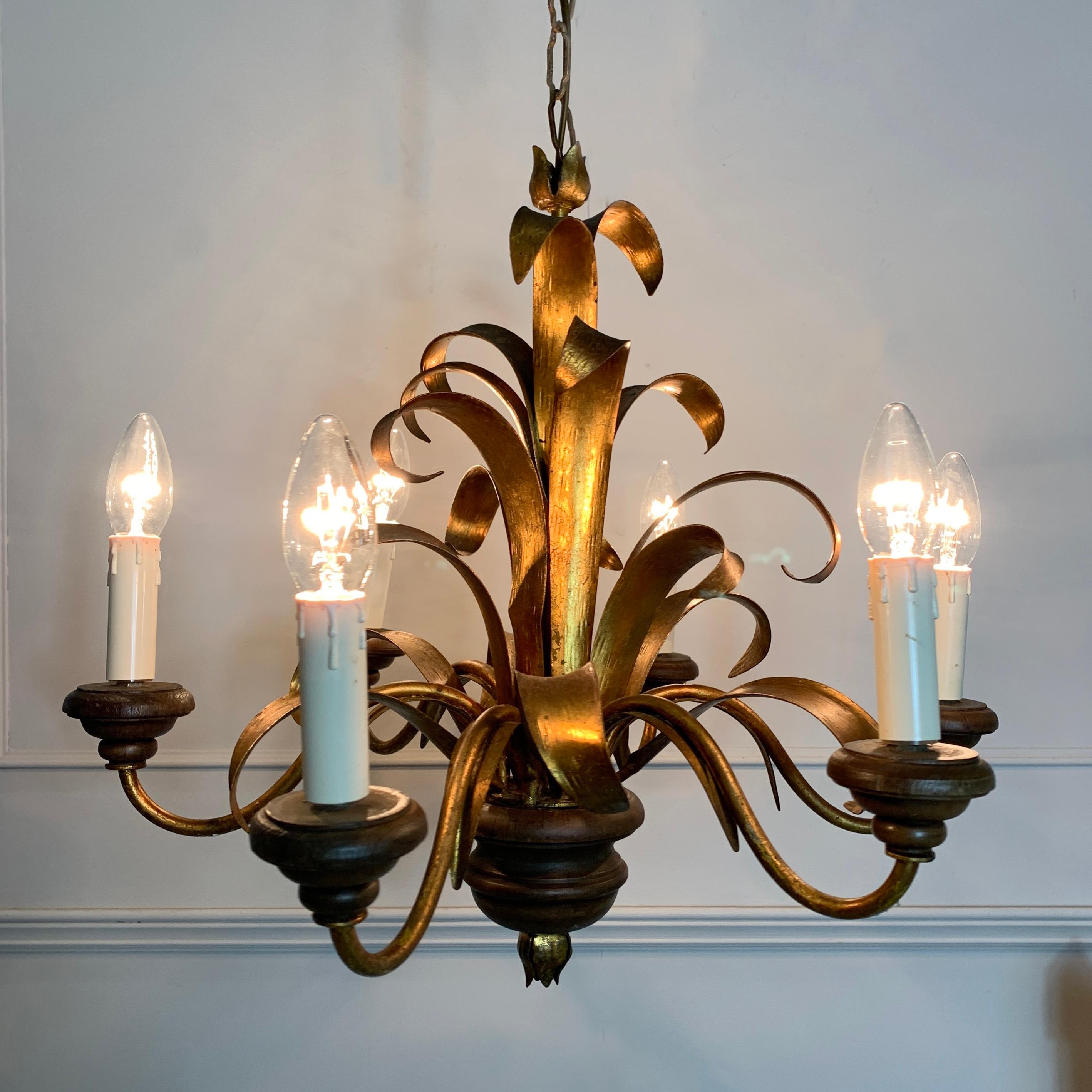 Italian Broad Leaf Gilt Chandelier, C 1970’s
Wide Gilt Metal Leaves Form A Frond At The Centre Of This Chandelier
There Are 5 Metal Arms With Turned Wooden Cups Holding 5 Lampholders, E14
There Is Also A Turned Wooden Finial Base With Gilt Leaf