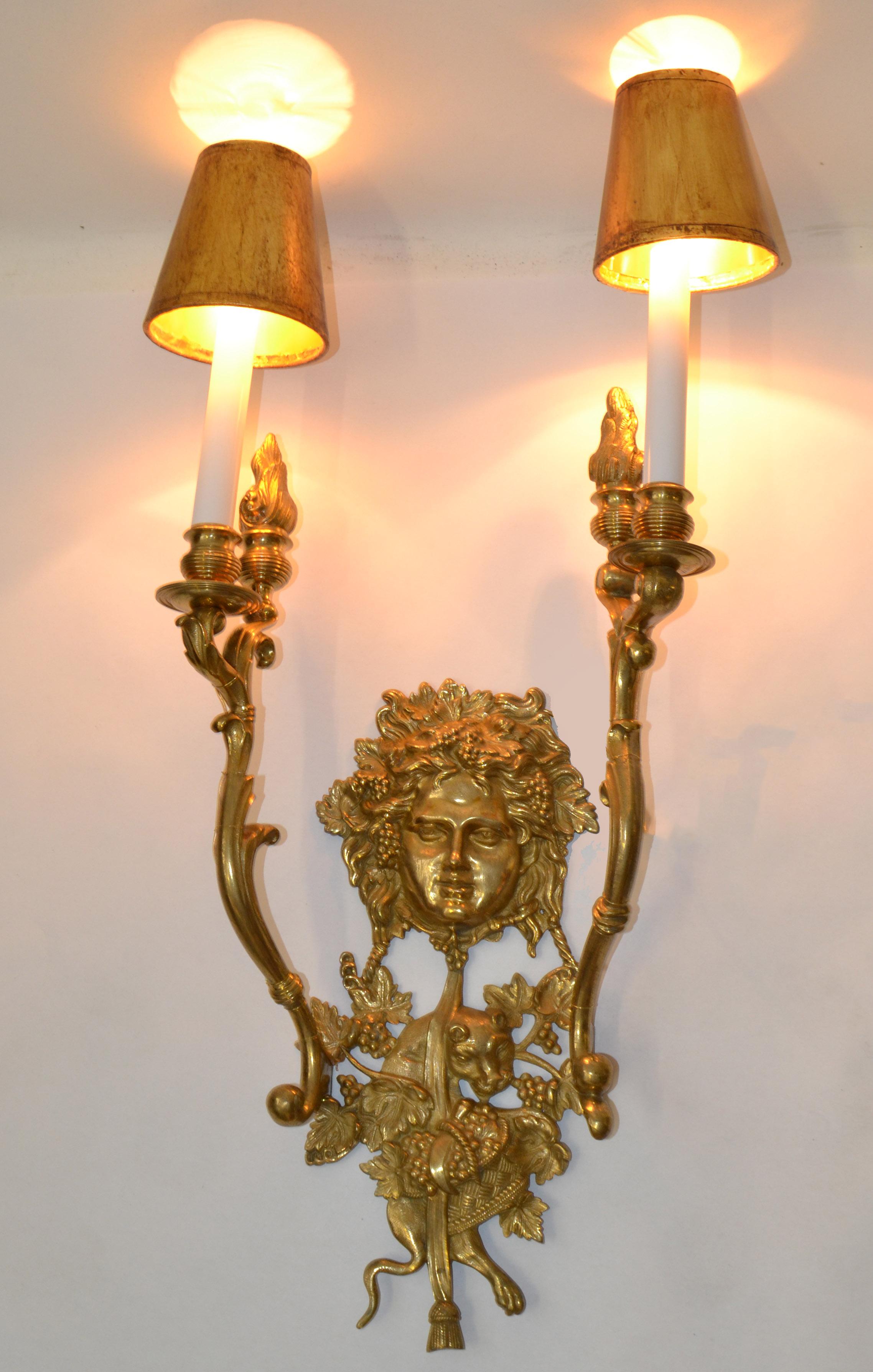 Italian polished Dore bronze two flame torch arm sconce with Bacchus masks in the center, Panther and Grapes all around. 
The Wine God Bacchus Theme all over. 
This Wall Light comes with the original gilt clip on Shades.
Newly Rewiring for the US