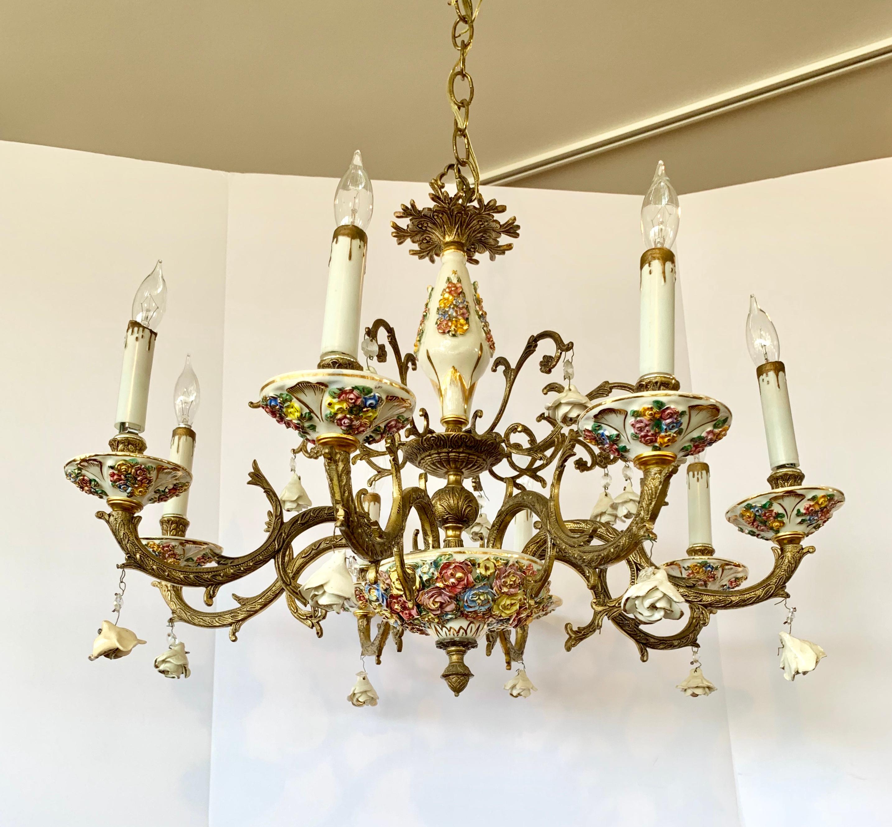 Elegant neoclassical antique Italian bronze and porcelain chandelier with raised petals in several different
colors give this item a one of a kind look. Wired for USA and has eight arms and eight respective bulbs.