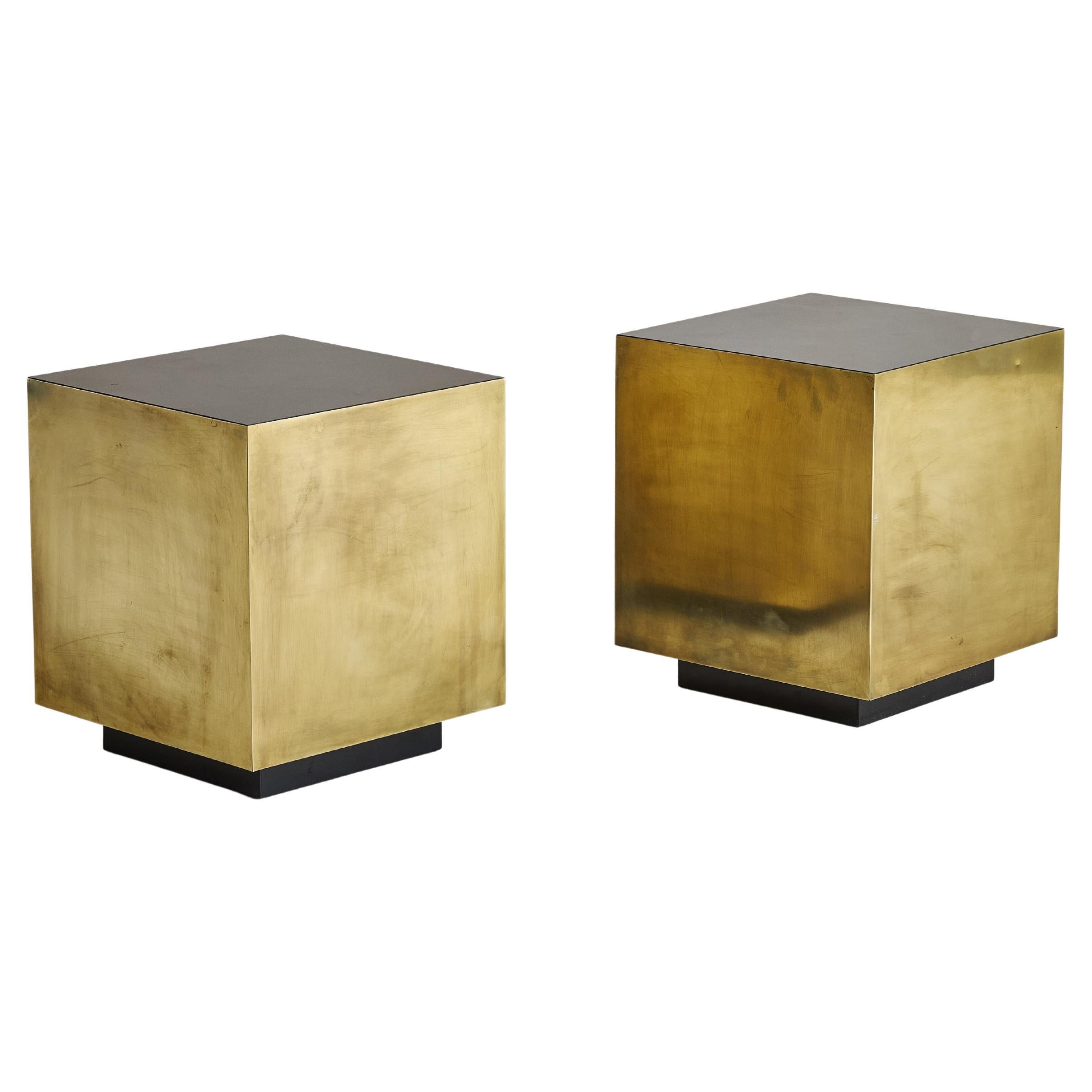 This Italian bronze cube side table is a striking example of 1970s modernist design, featuring a minimalist form and luxurious patinated finish. Its low-profile silhouette is subtly elevated on a black plinth base. Perfect as a statement piece
