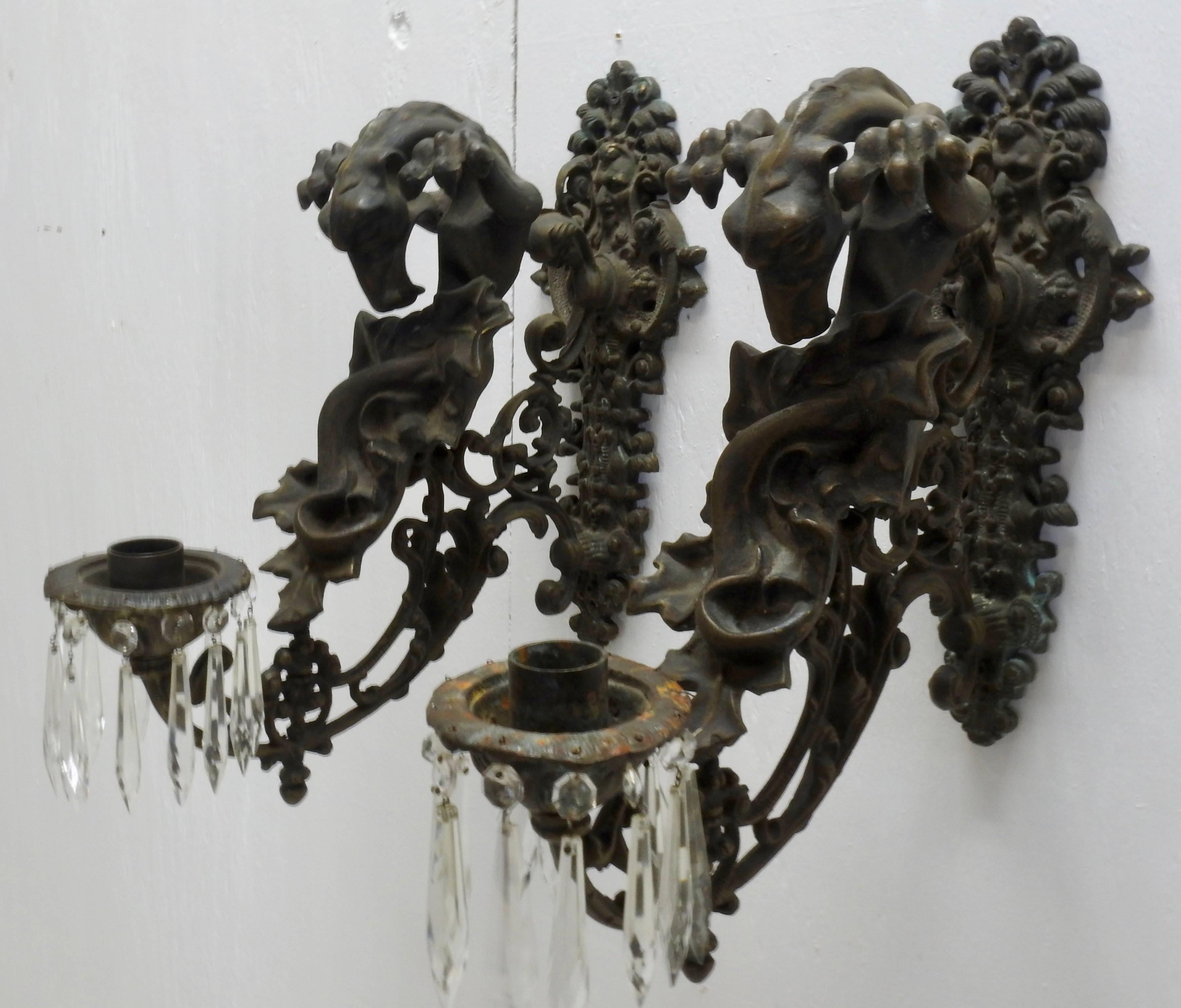A unique pair of Gothic Gargoyle candle sconces with amazing details. The gargoyles are looking down to the spot where candles or a wired light would be. They have there claws up and curled and all the gorgeous scrollwork and foliate detail below is