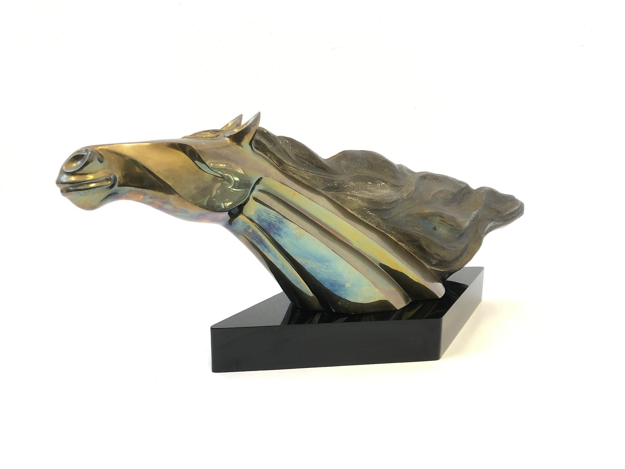 A beautiful cast bronze horse head sculpture by Italian Sculptor Maxime Delo from the 1980s. The sculpture is constructed of cast bronze and sits on a black acrylic base. Signed M. Delo and numbered 13/150.
Measurements: 32” wide, 10.5” deep and