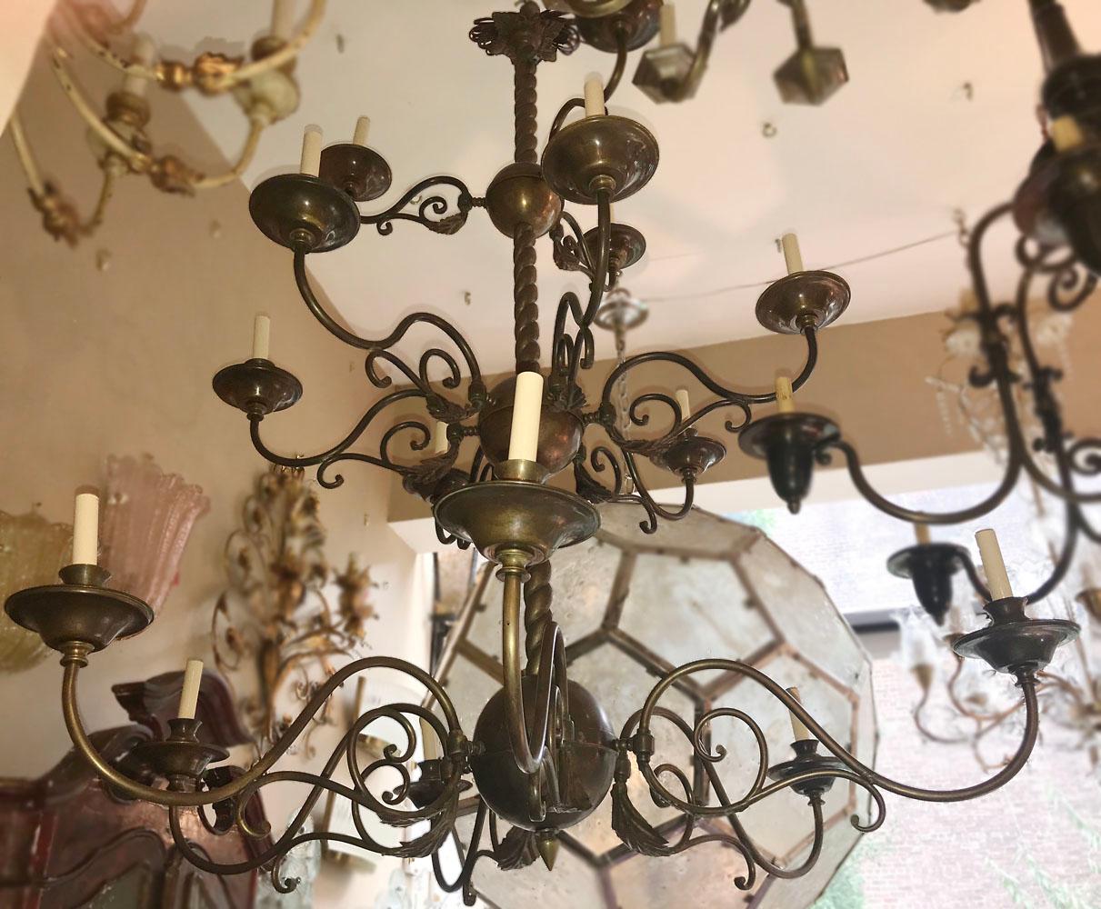 An Italian patinated bronze chandelier with double tier, foliage details on arms, original patina.
Measurements:
Height: 56