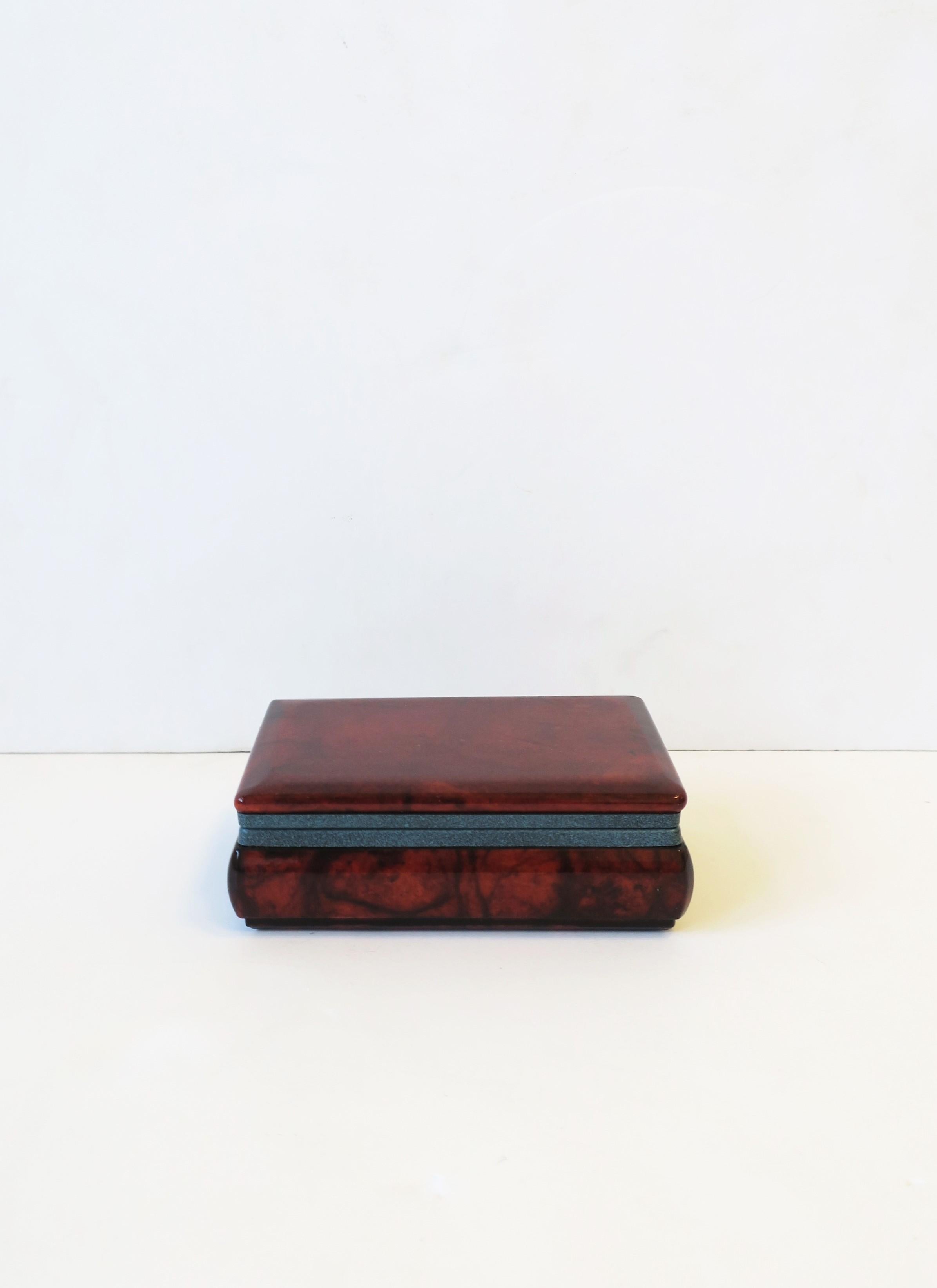 An Italian dark brown alabaster marble jewelry box with a blue matte metal hinge. Box can hold jewelry or other small items. A great piece for a desk, vanity, nightstand, walk-in closet area, etc. Marked made in Italy on bottom as shown in last two