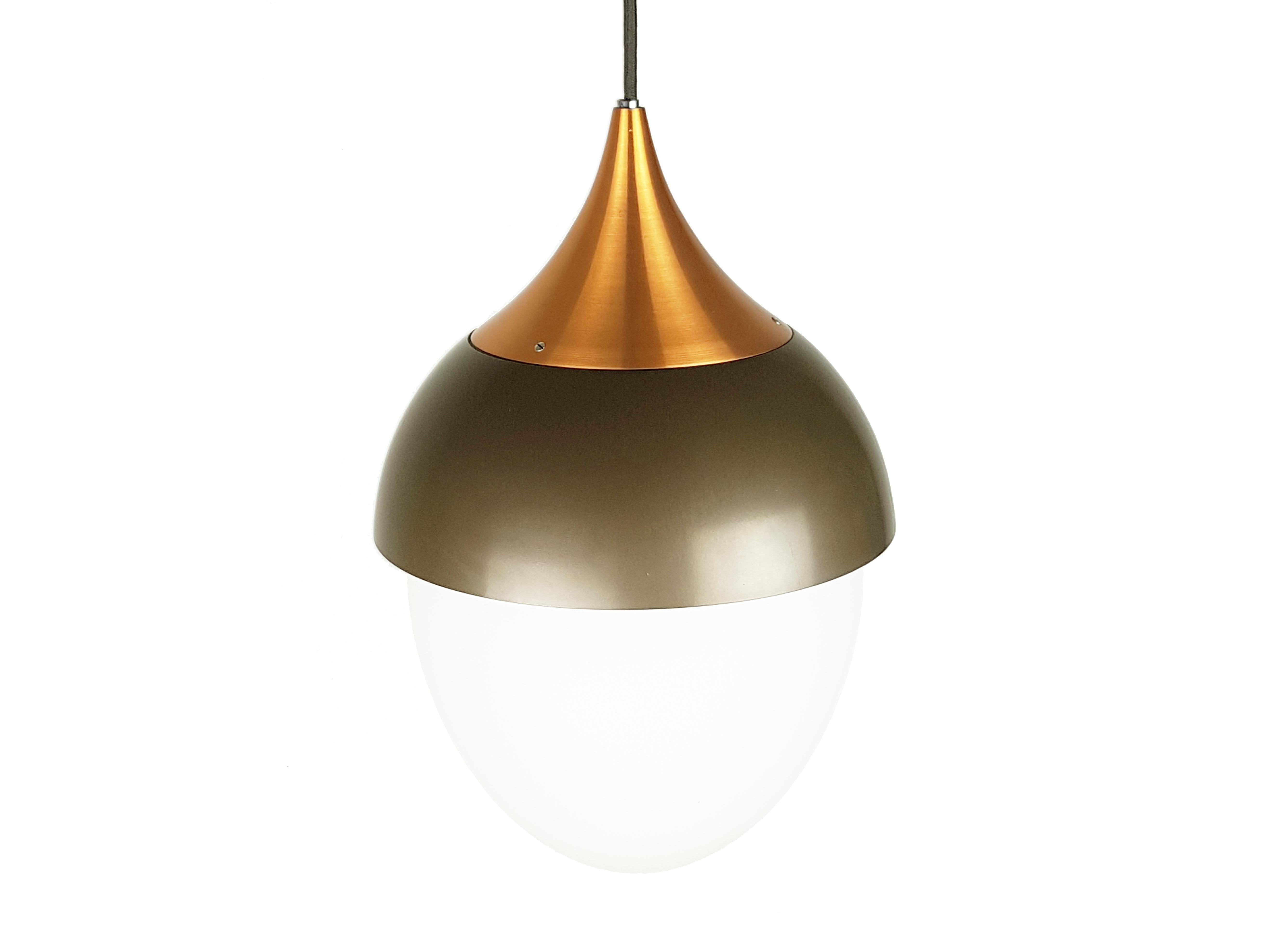 A rare and elegant pendant lamp produced by Stilnovo in the 1960s.The main body of the lamp consists of 3 elements: 2 in brown and copper painted metal and a white sandblasted glass lampshade. Its design resembles the shape of an acorn. 
Stilnovo