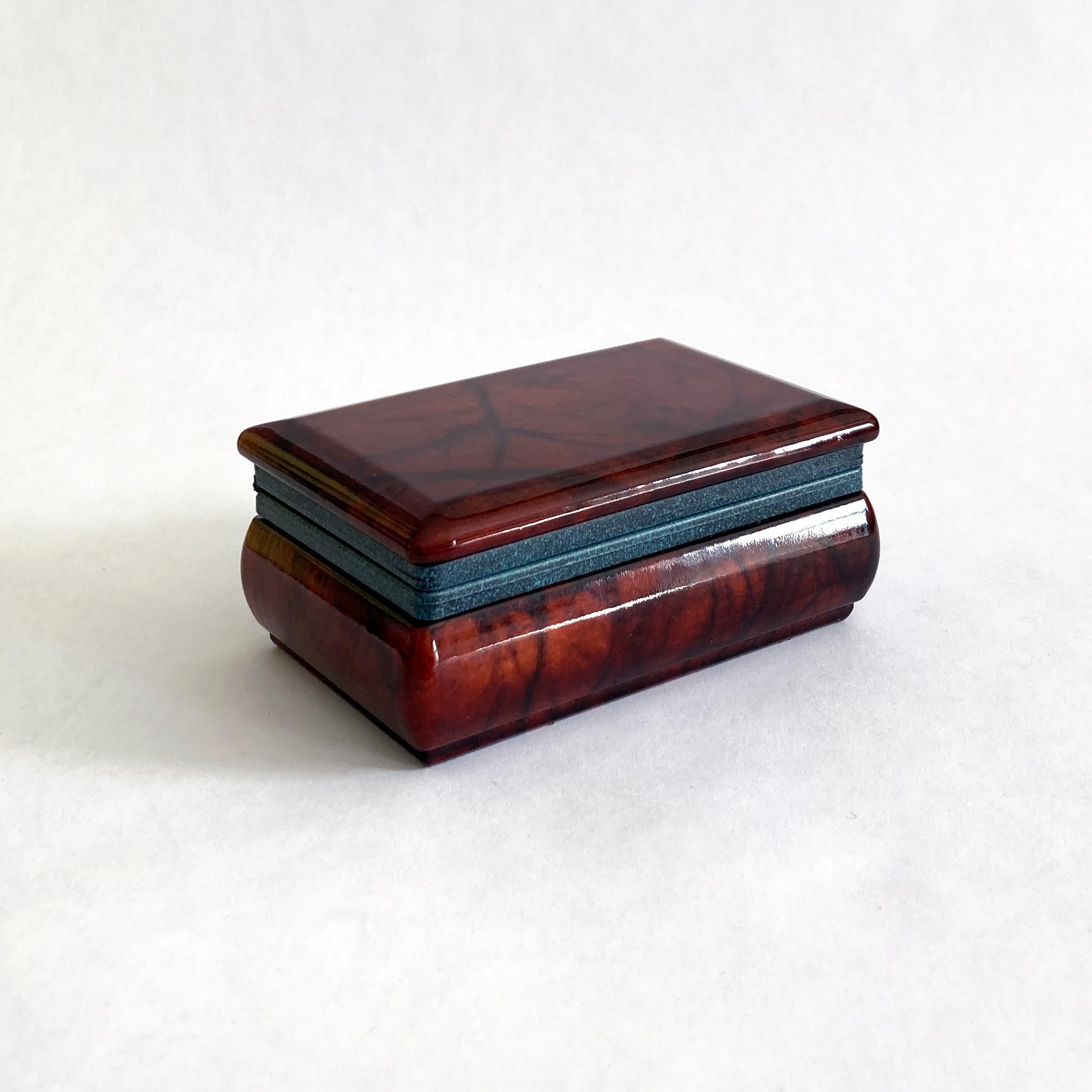 Beautiful petite brown/ red hand carved alabaster hinged box. The brownish red alabaster contrasts beautifully with the blue toned hinge hardware. This piece looks great as part of a group, or independently on a dresser or side table. See photos of