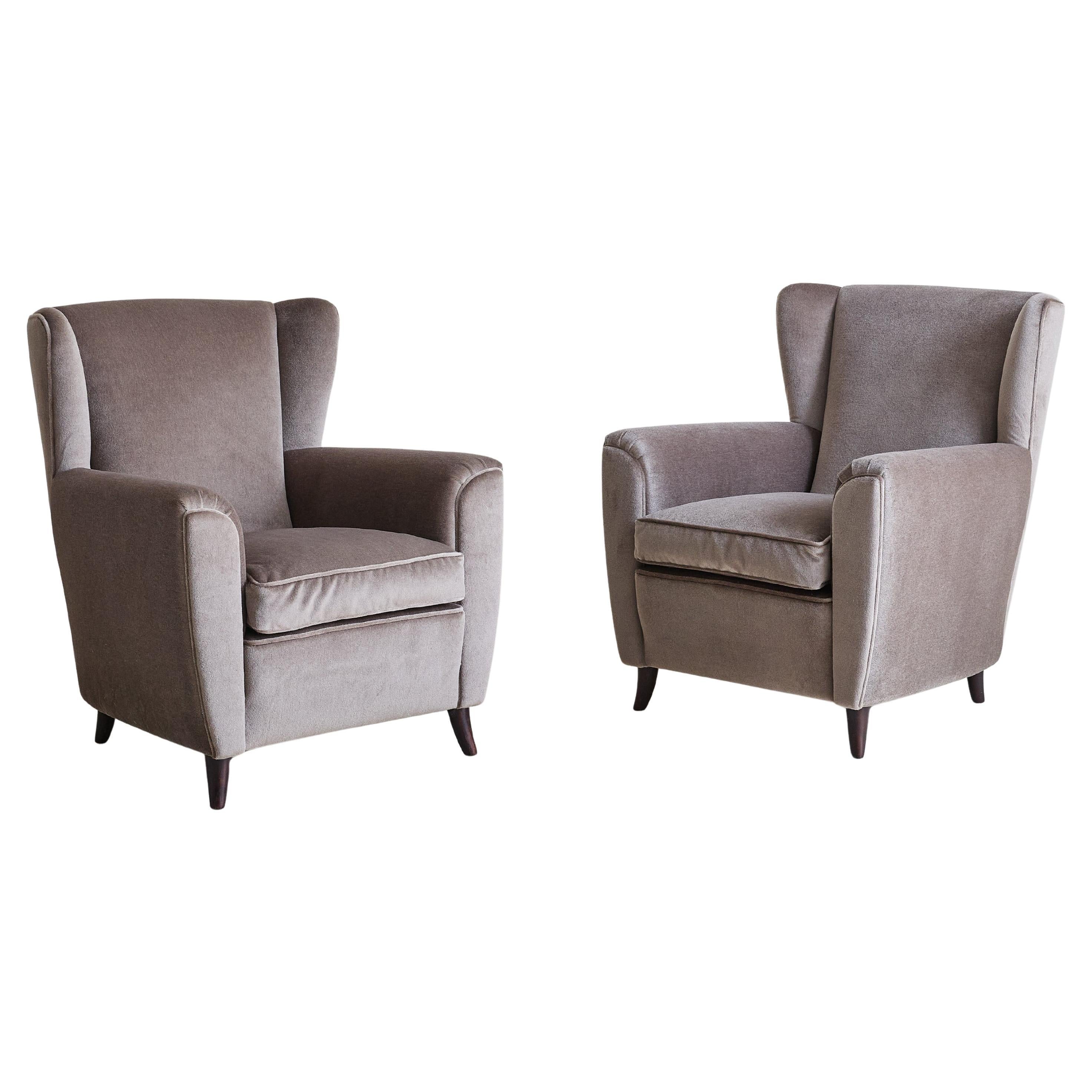Sold and priced individually.

A 1950s Italian lounge chair, reupholstered in soft, muted brown velvet with a luxurious sheen. The clean, tailored lines are complemented by gently angled arms and a softly contoured wingback. The deep seat, fitted