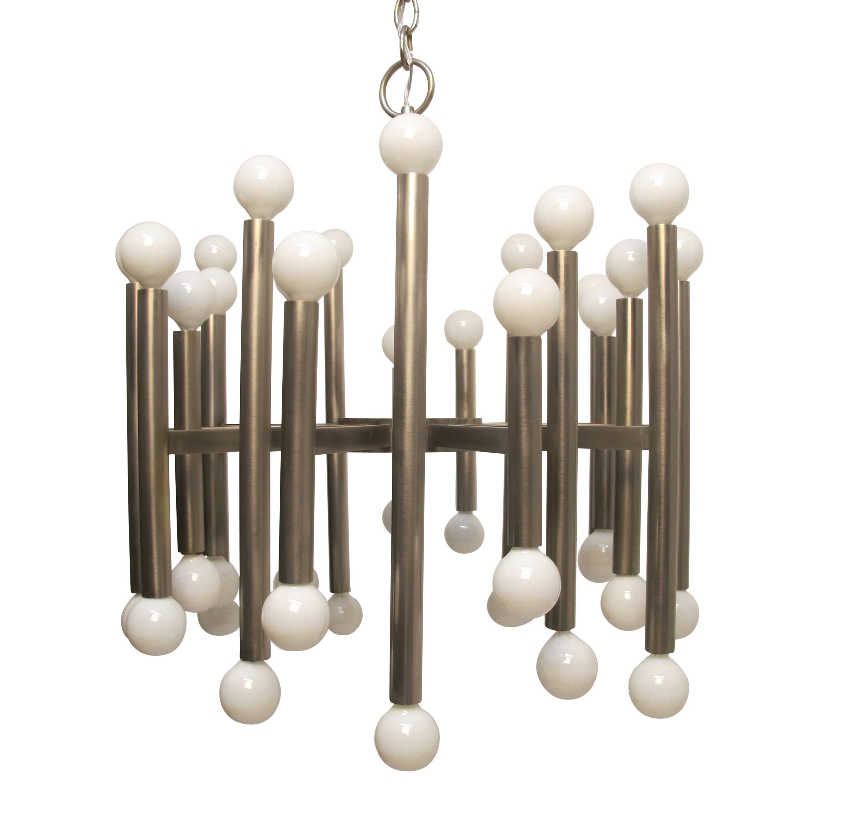 A Gaetano Sciolari brushed stainless steel twenty-arm light fixture with sockets at each end of the extended tube arm. Recently refurbished and re-wired, holds chandelier base bulbs, Italy, mid-20th century.