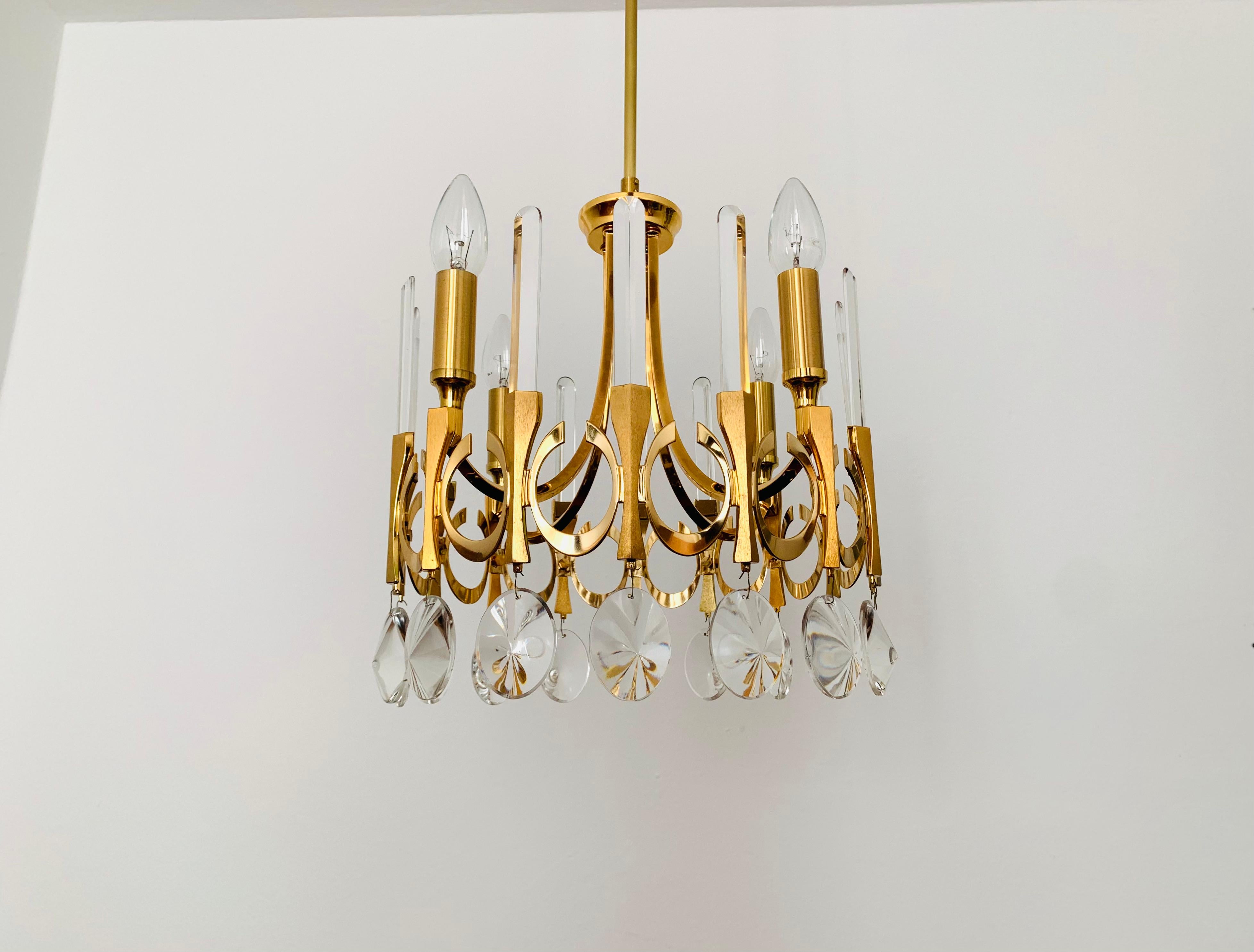 Wunderschöner brutalistischer Kristallglas-Kronleuchter aus den 1960er Jahren.
Äußerst erfolgreiches italienisches Design.
Es erzeugt ein sehr angenehmes und funkelndes Licht.

Entwurf: Gaetano Sciolari

Bedingung:

Sehr guter Vintage-Zustand mit