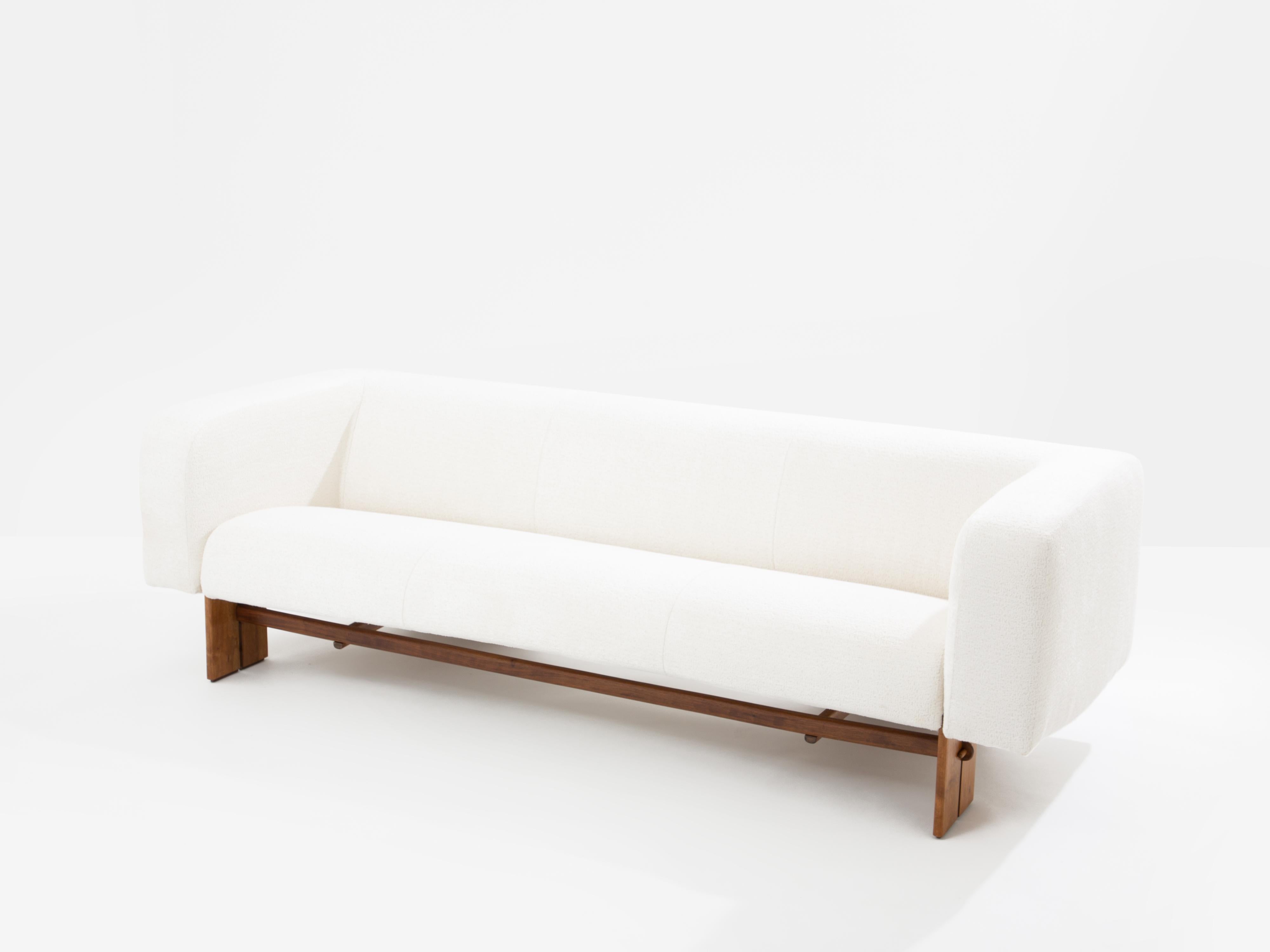 Beautiful brutalist three seater sofa from an anonymous Italian designer created in the 1960s. The feet and structure are made of solid walnut, with beautiful details and craftsmanship. The seat features high-density foam cushions with sharp lines,