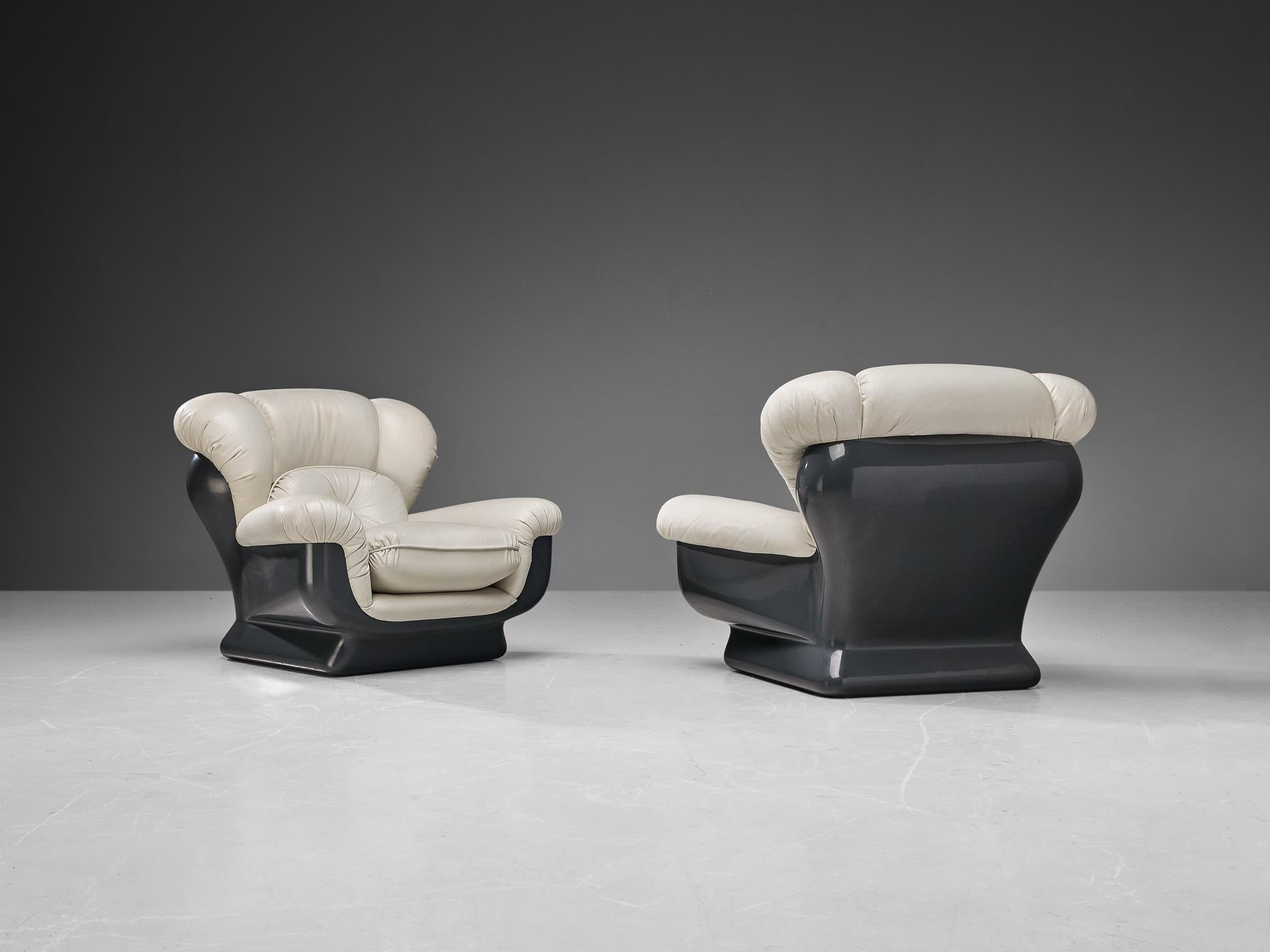 Pair of lounge chairs, fiberglass, faux leather, Italy, 1970s

A pair of very enjoyable bulky pair of  lounge chairs in leatherette. These chairs are the ideal fit for anyone looking for comfort. The large cushioning makes the sitter feel like they