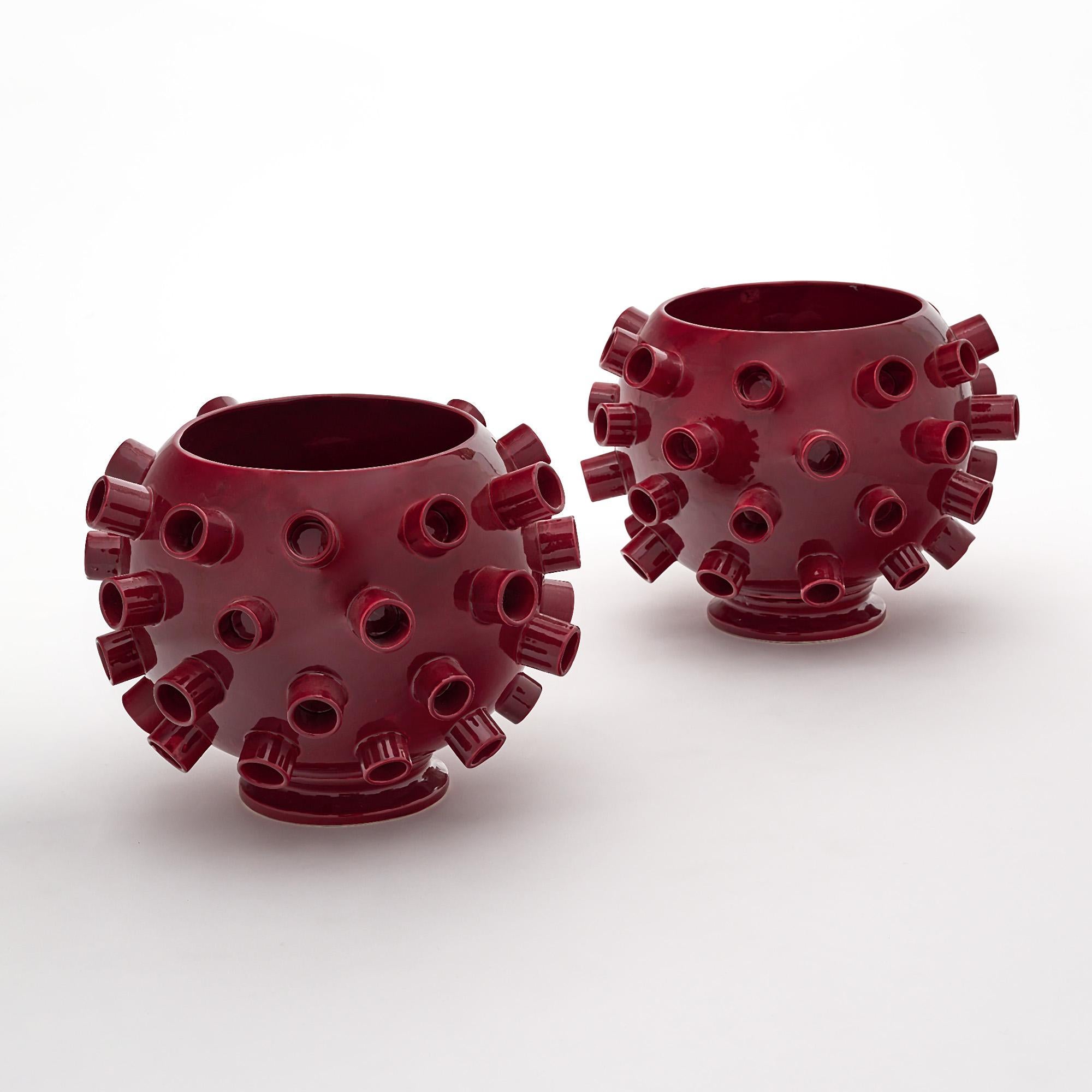 Pair of vases, in the Brutalist style, from Verona, Italy. This pair is made of ceramic with a burgundy glossy glaze. They are signed MC for artist M. Costa.