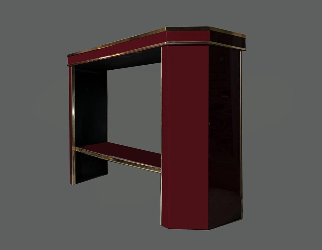 Italian Burgundy lacquered and brass console table with, brass edges, glass cover top.
 