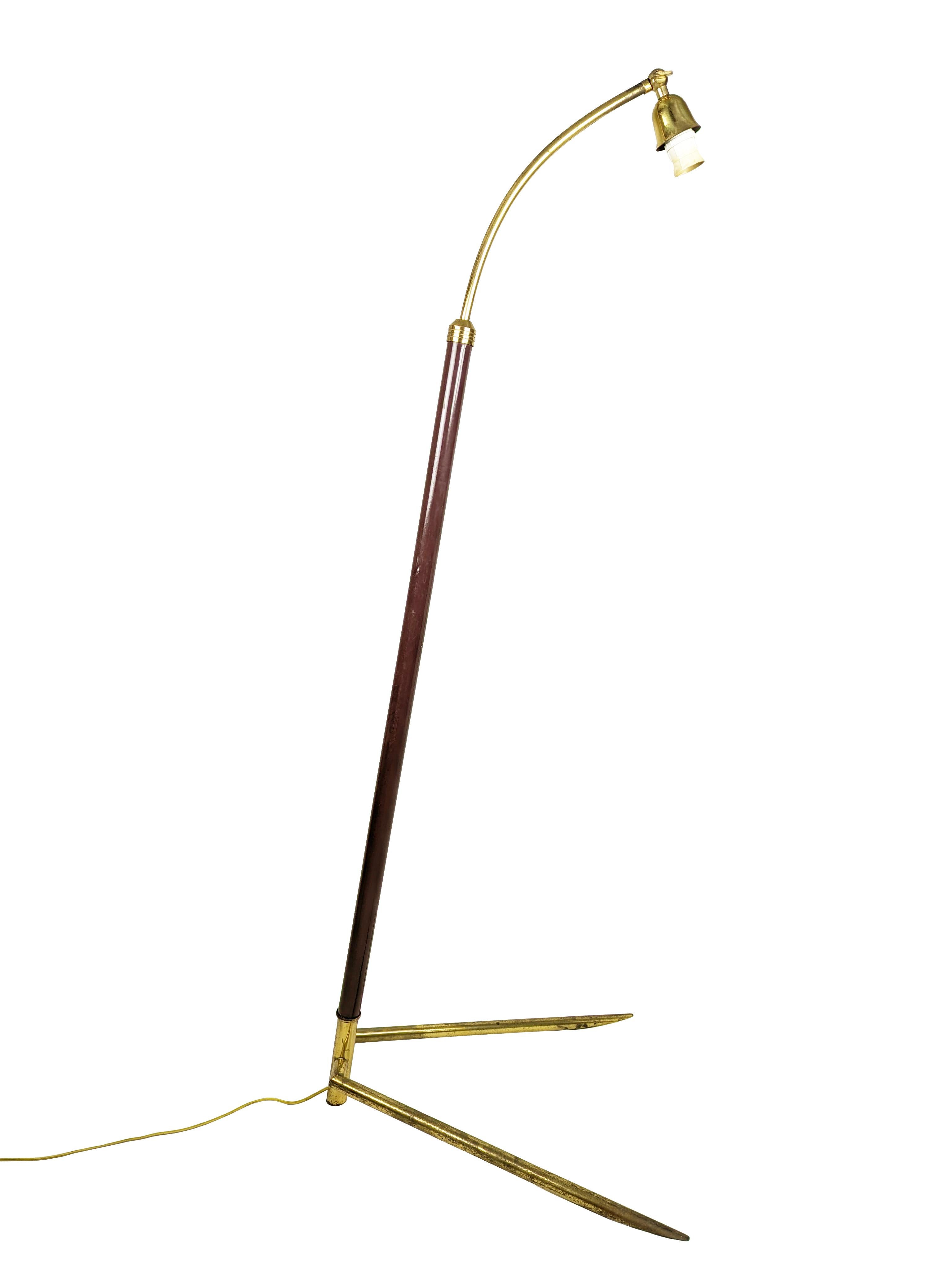 Mid-century modern floor lamp produced in Italy around the 1950 in a rare tripod base version. Brass base, burgundy painted rod with adjustable height: from cm 138 to 200 max. The lamp remains in working condition: the electrical system has been