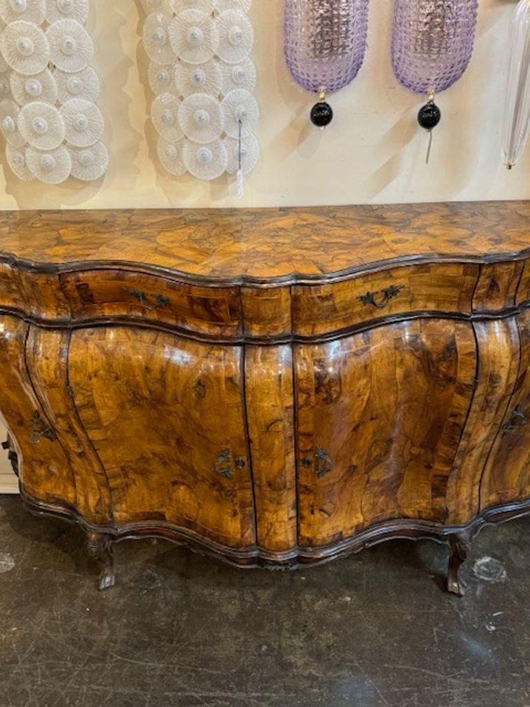 Handsome 19th century Italian burl walnut bombe shaped sideboard. Circa 1890. Adds warmth and charm to any room!