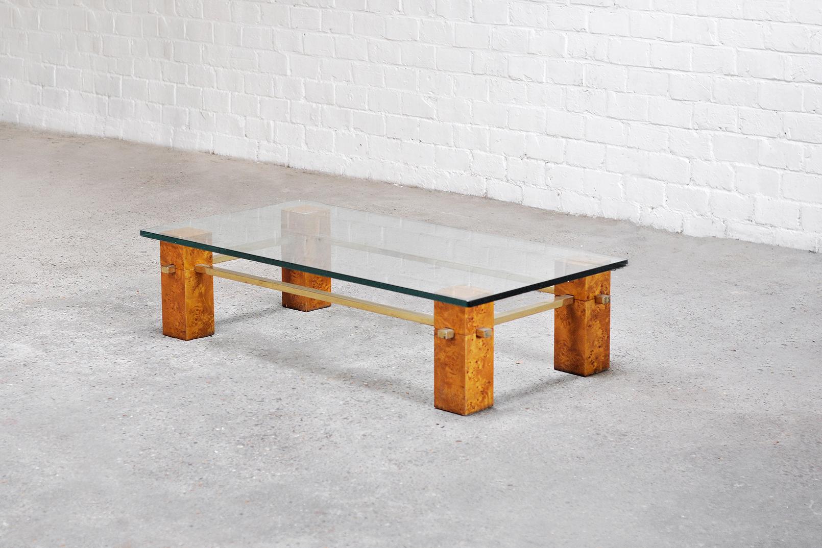 Beautiful Italian 1970s burl wood coffee table. Constructed out of burl wood legs connected by a brass structure. Thick glass top. This piece is attributed to Willy Rizzo.

Wear consistent with age and use, in good vintage condition. Patinated