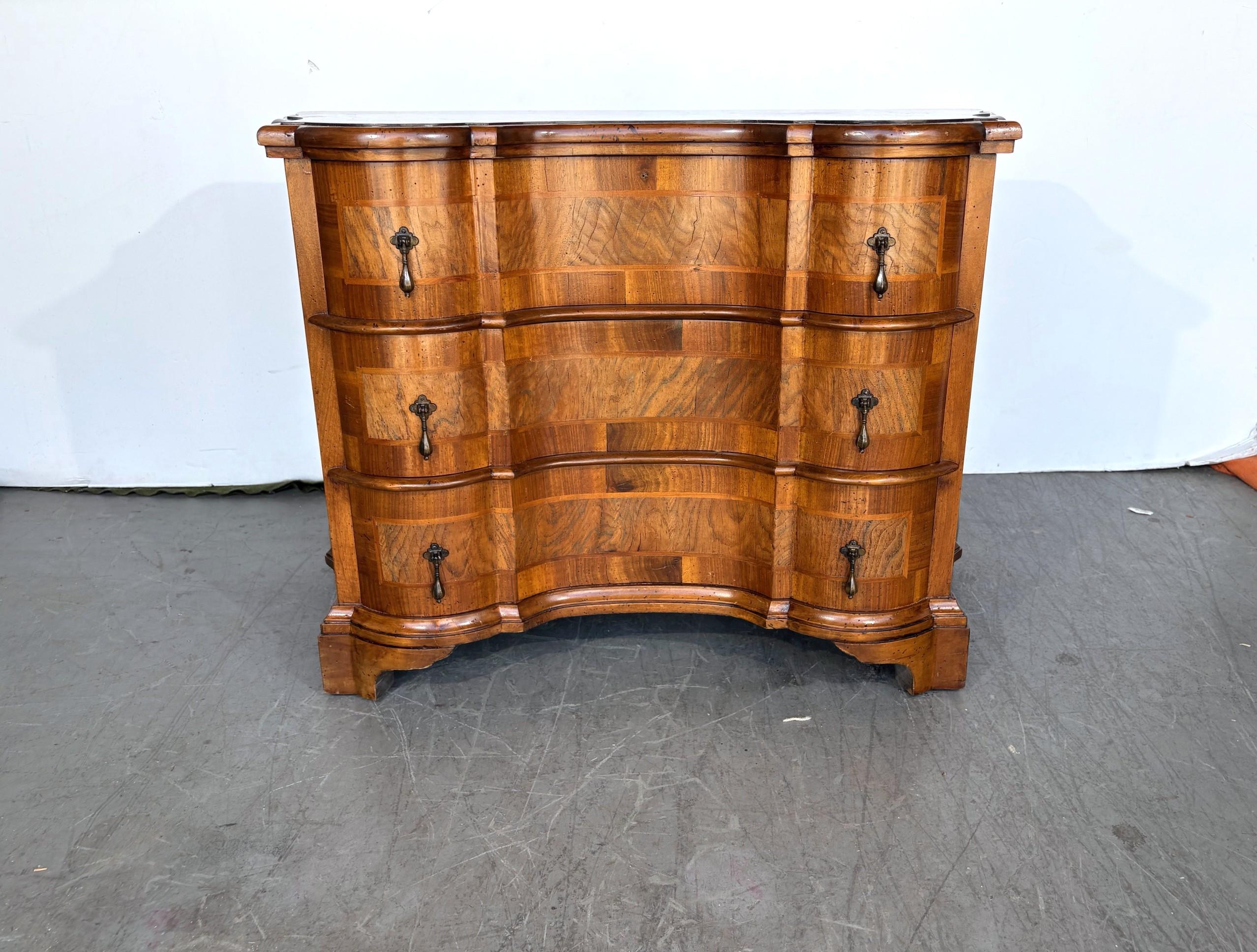 An Italian burlwood three-drawer commode.