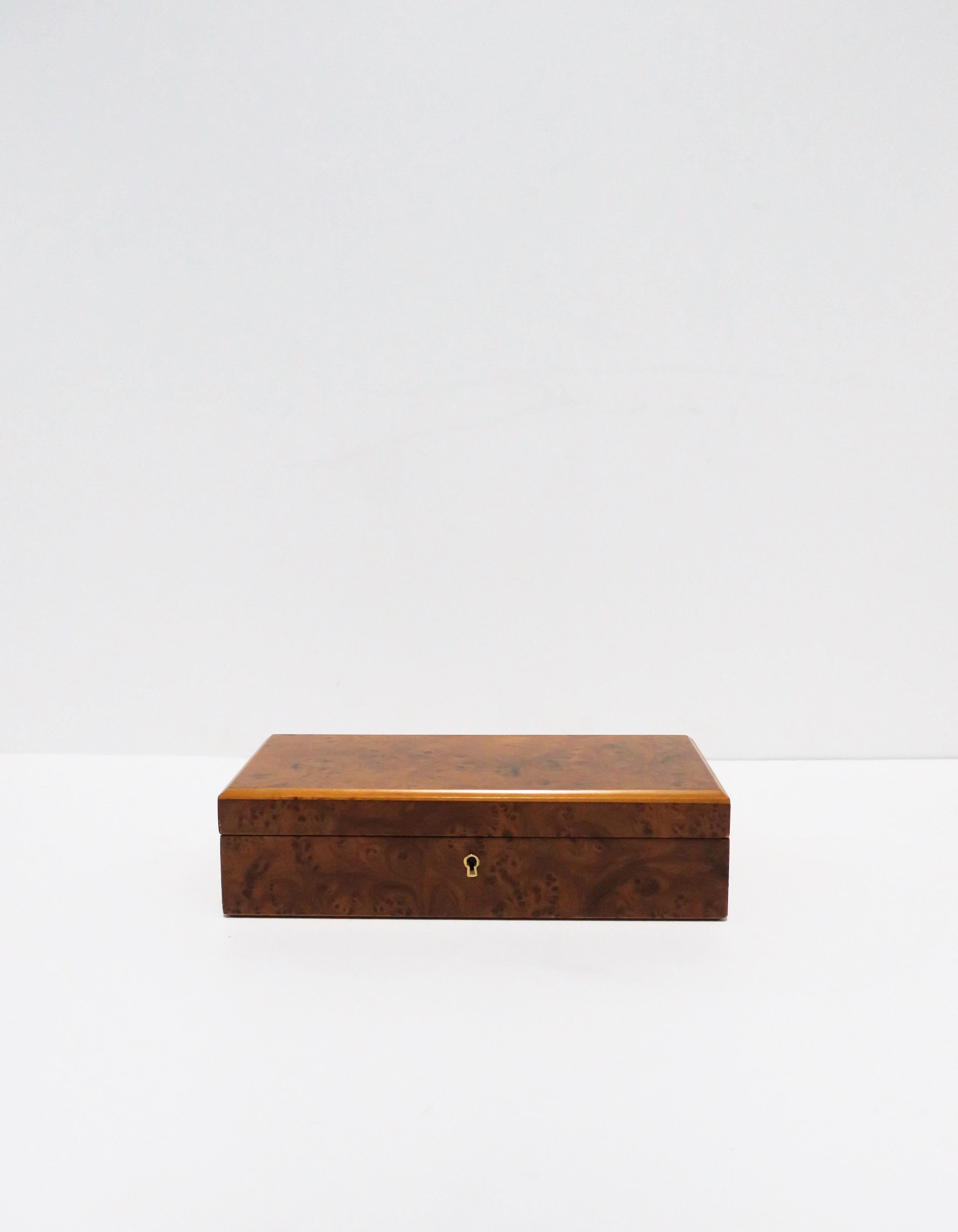 An Italian burl wood veneer jewelry box with velour interior and brass hardware, circa 20th century, 1960-1970s, Italy. Box has a nice easy open/close. Marked on bottom: 