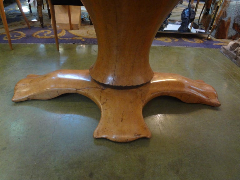 Exceptional Italian organic modern burled olive wood oval center table or dining table attributed to Osvaldo Borsani. This outstanding Neoclassical style pedestal table has a most unusual sculptural base. 
This sensational and unusual one of a kind
