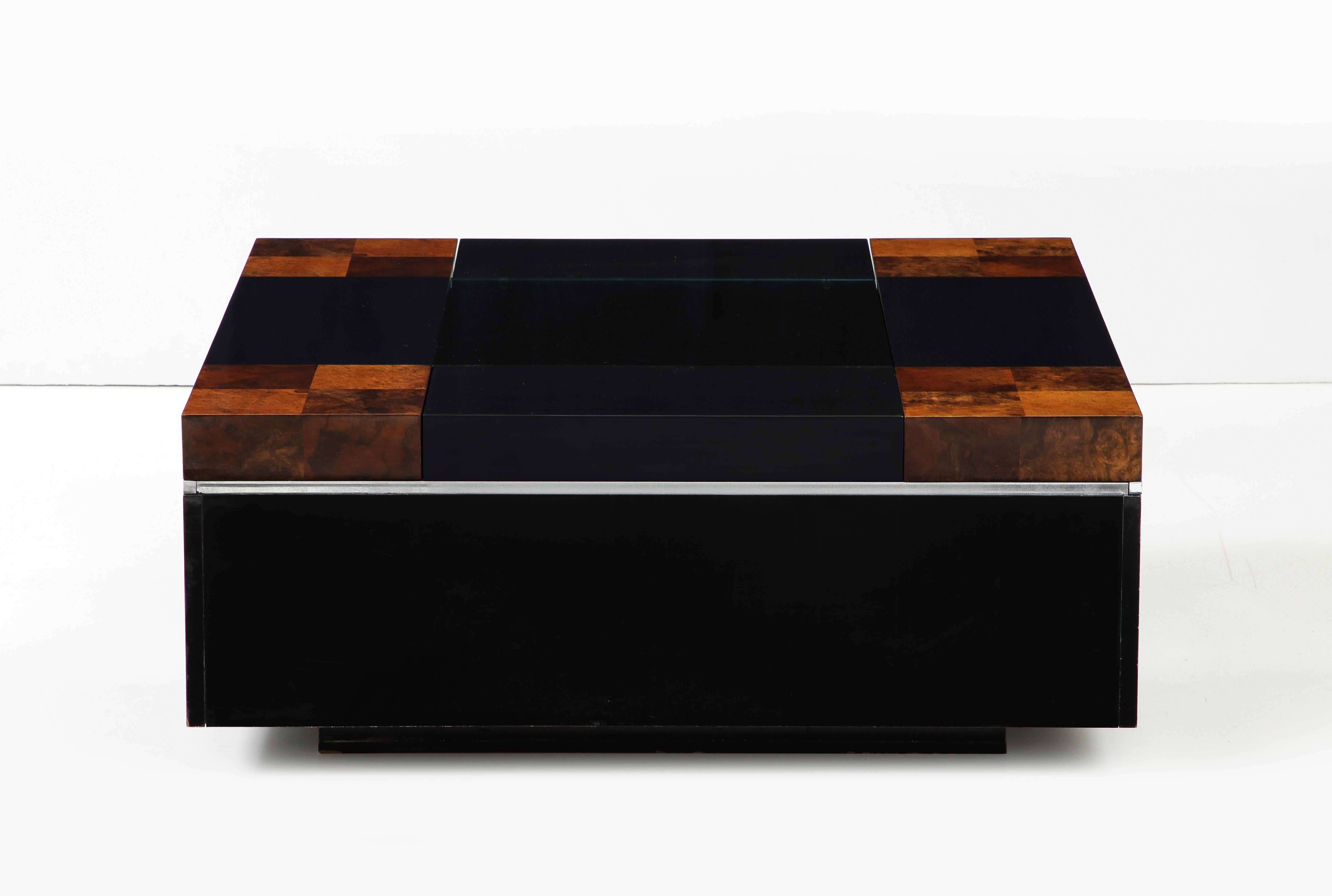 A Willy Rizzo floating square coffee table in burl wood and lacquer with chrome trim with smoked glass inset top.  The sides slide open to reveal storage, originally used for a bar.  The corners are stained for a checkerboard motif.  Very chic and