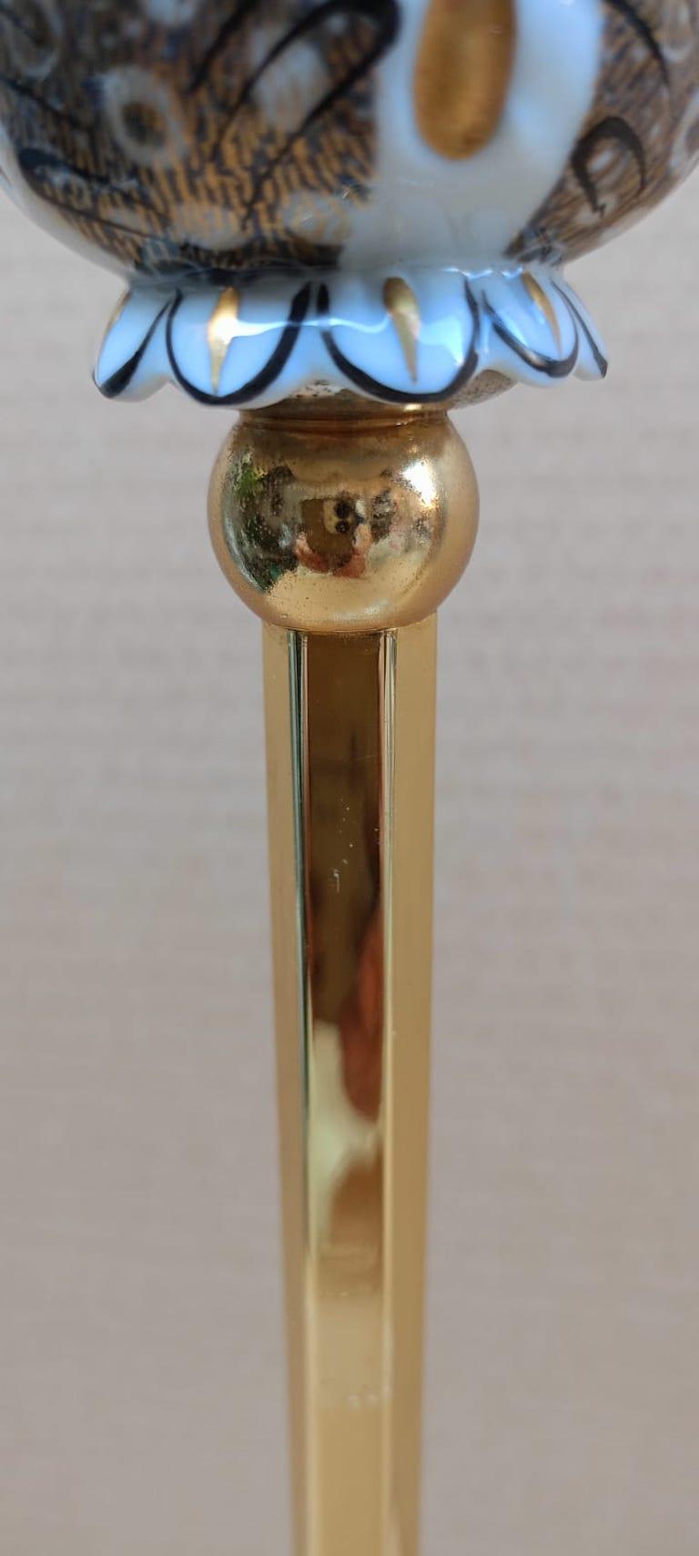 The grand scale a porcelain, a pair of candlesticks made of gilt and glazed porcelain on the brass stem in the shape of the tulip, signed and monogram on the base, largest is: 54cm. tall and 12cm in diameter 21.4in. x 4.5in. 
Smaller:43cm. tall and