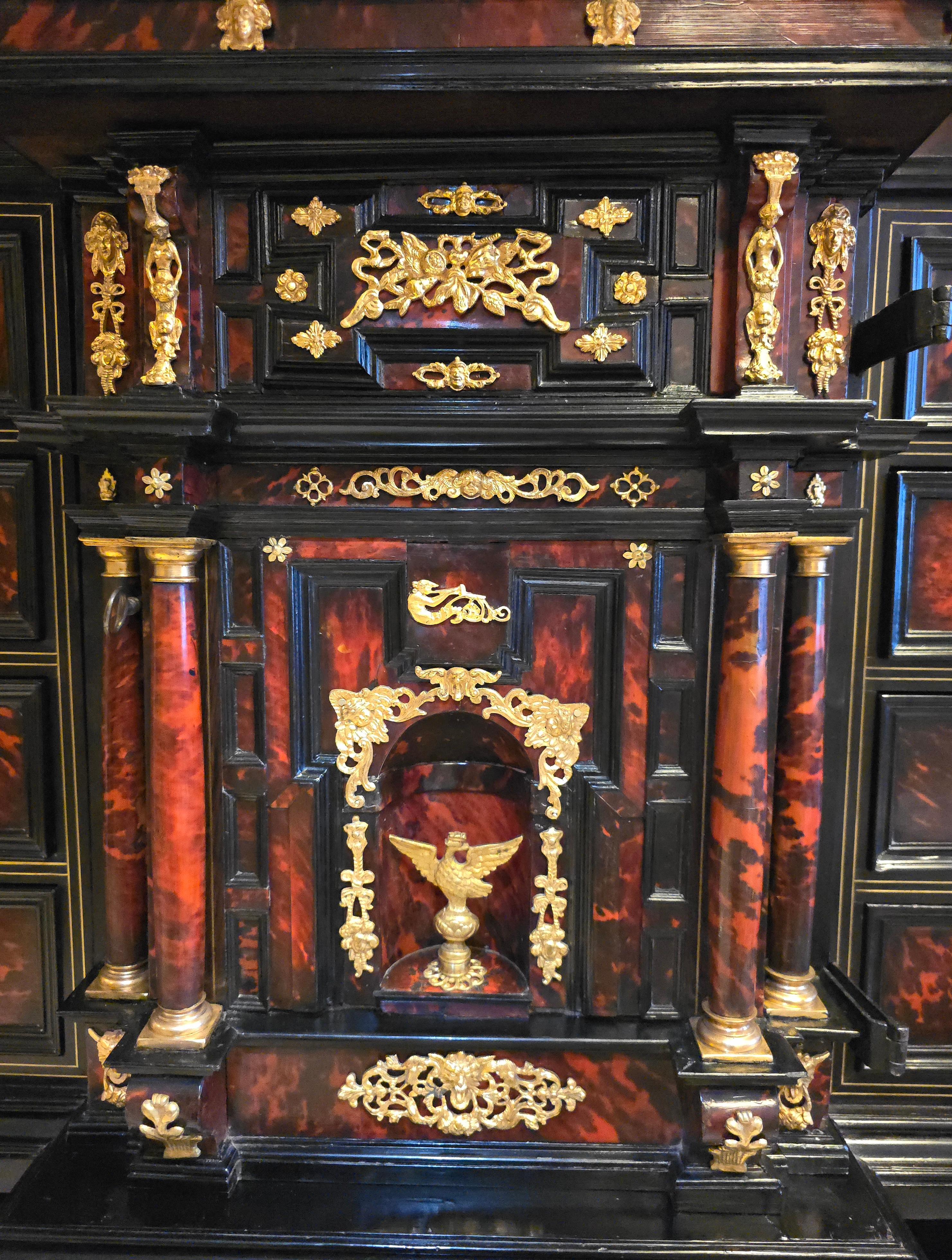 This remarkable 17th-century Italian cabinet is a masterpiece of craftsmanship, combining ebony and ebonized wood with tortoiseshell plaques, finely worked brass mounts, and delicate brass inlays. Designed in the architectural style popular during