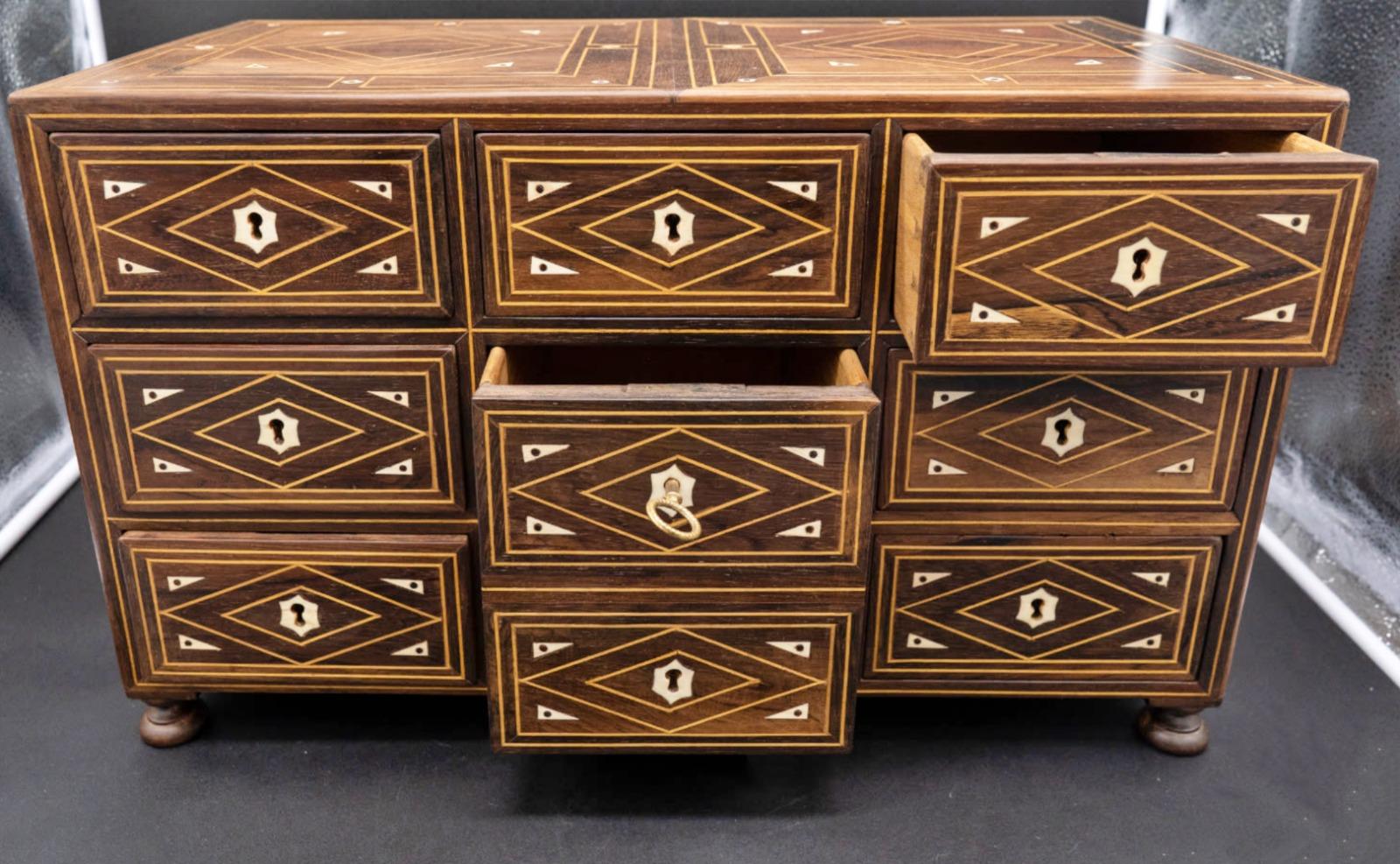 Italian cabinet 19th Century in Rosewood

With inlays in wood and noble material.
With eight drawers, with golden metal handles on the side, 
in good condition. 
32cm * 52.5cm * 27.5cm.



