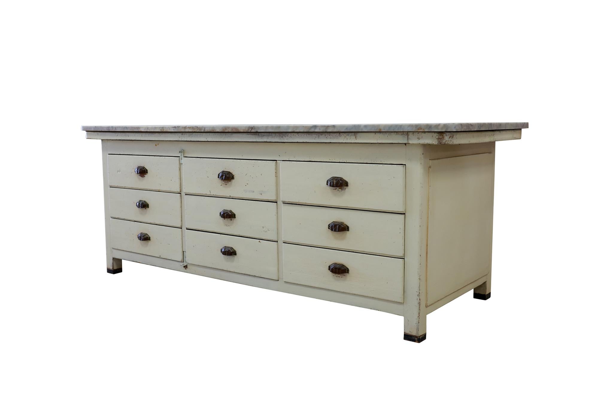 Italian counter or cabinet from a bakery, base has 9 drawers and wonderful original paint, includes original marble top, circa 1910.

Dimensions: 34.5H x 92.25W x 36.25D
