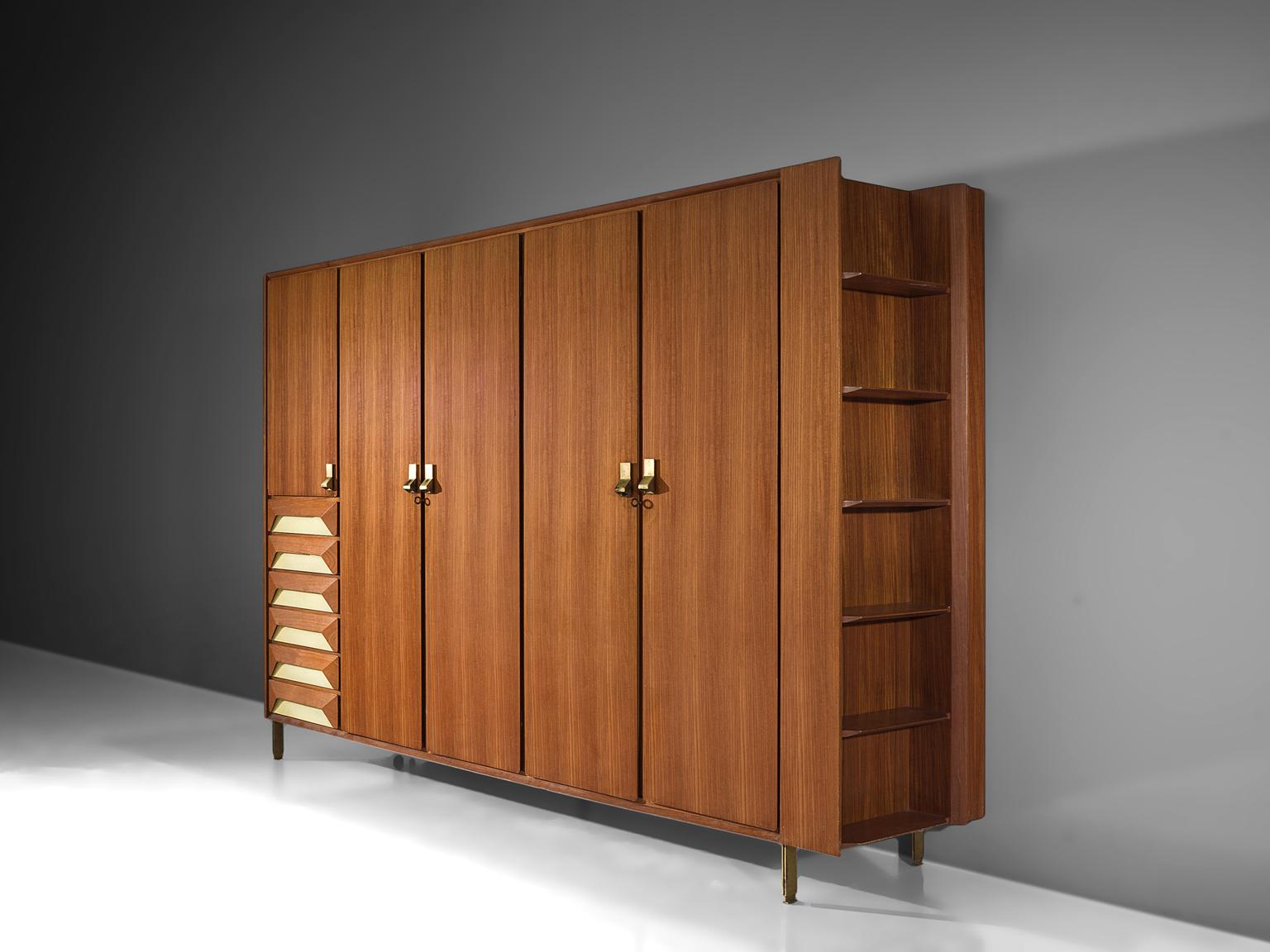 Cabinet, teak, brass, Italy, 1950s.

This grand cabinet is executed in teak with brass details on handles and legs. The cabinet features a compartment with six drawers. Each of the drawers have a an off-white background by means of which the