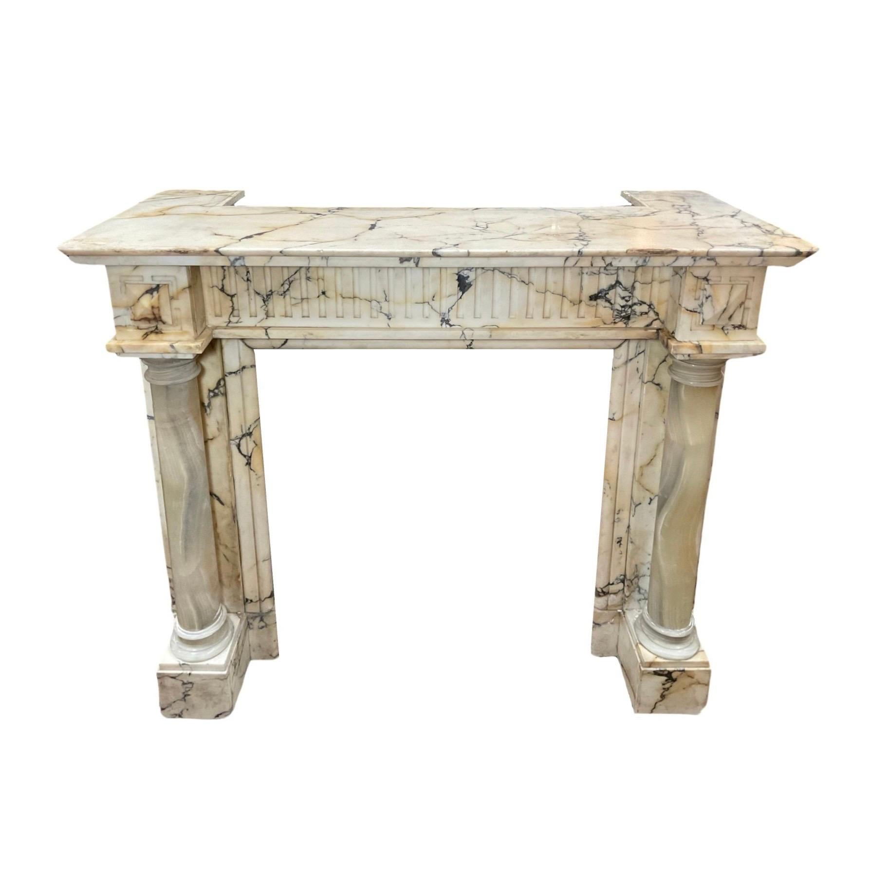 This exquisite Italian mantel, crafted out of Calacatta marble from the 1860s, is the perfect addition to any home. Boasting yellow hue that results from the aged marble, the mantel adorns onyx stone legs for added elegance. Add timeless beauty to