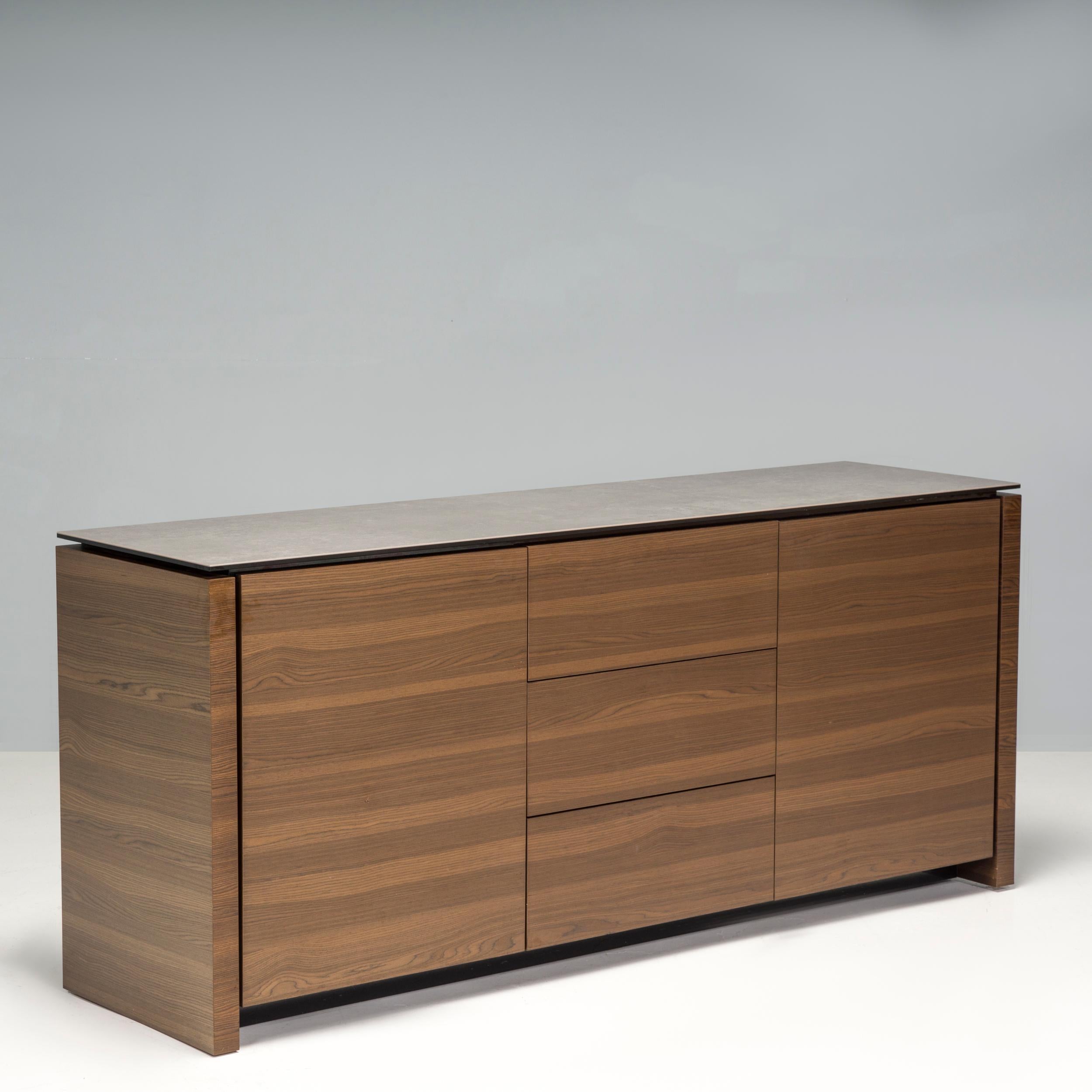 Designed and manufactured by Calligaris Studio, this Mag sideboard is a fantastic example of contemporary Italian design. Constructed from solid wood, the sideboard features separate compartments with a cupboard at each end and three drawers in the