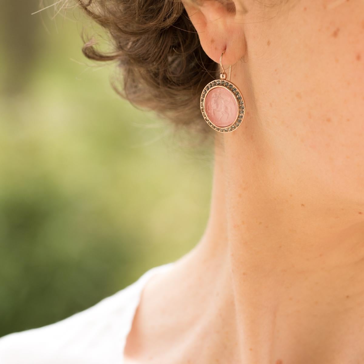 For pierced ears. 
Earrings in vermeil, silver and rose gold. Round shapes, they are each crimped in a closed setting, a cameo on glass paste representing a centaur lined on all round small cristals. The hanging system is a gooseneck with safety