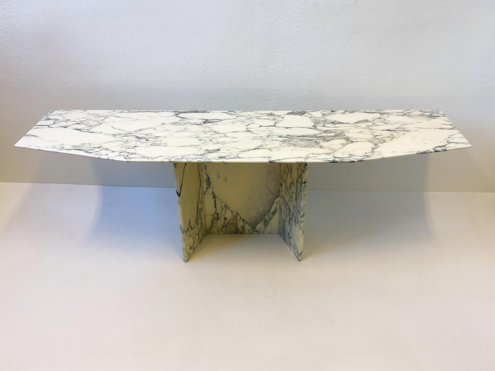 A spectacular 1970s Italian polish Carrara marble Console table. 
The top is flat on the back, a nife edge on the front and sides. 
The base has a silver powder coated steel top that support the marble top. 

Measurements 71” wide 19.75” deep