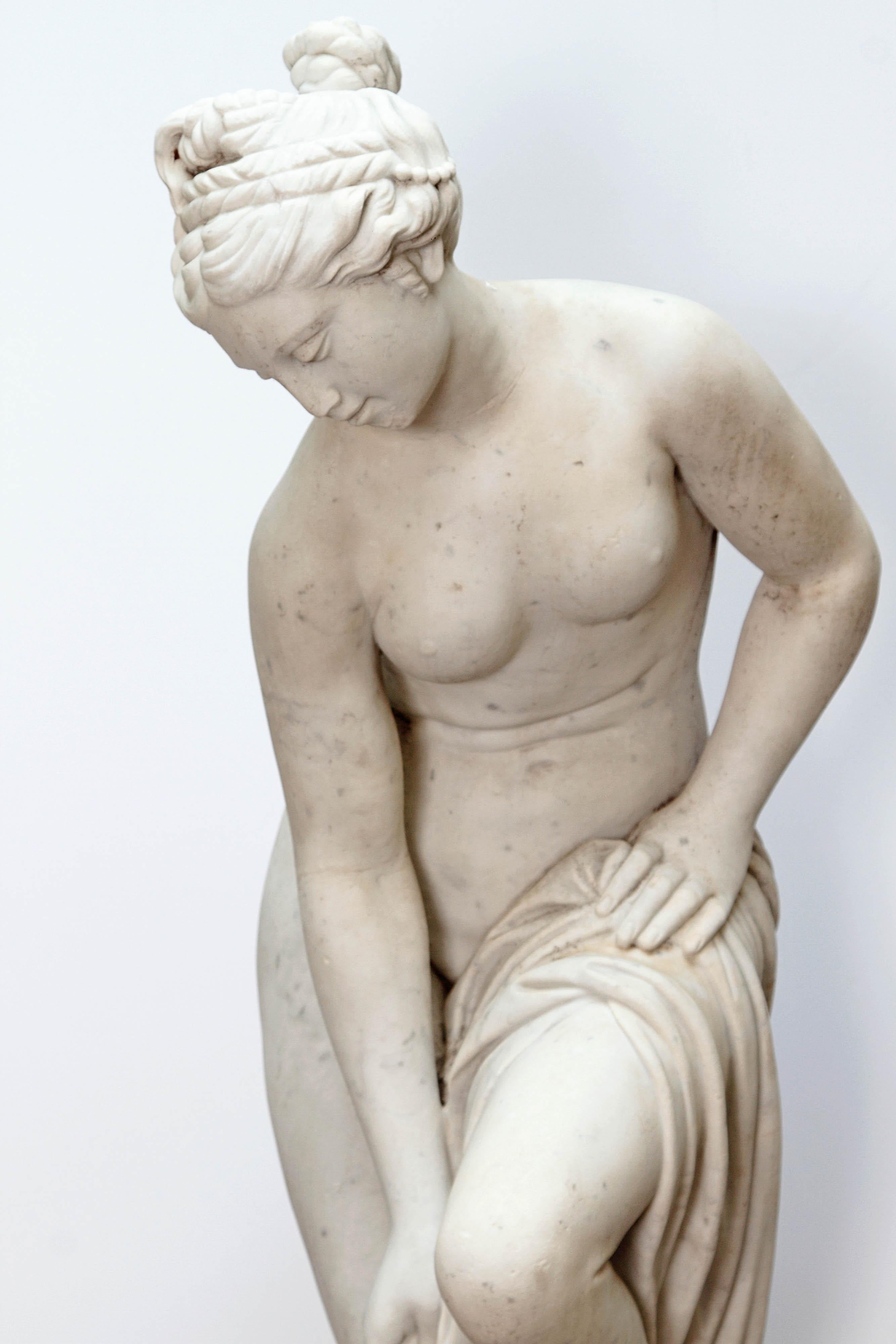 Italian Carrara marble life-size figure of Venus attending to her toilette. The partially nude figure is standing on a pedestal base. Unsigned,
Early 20th century.

  

 