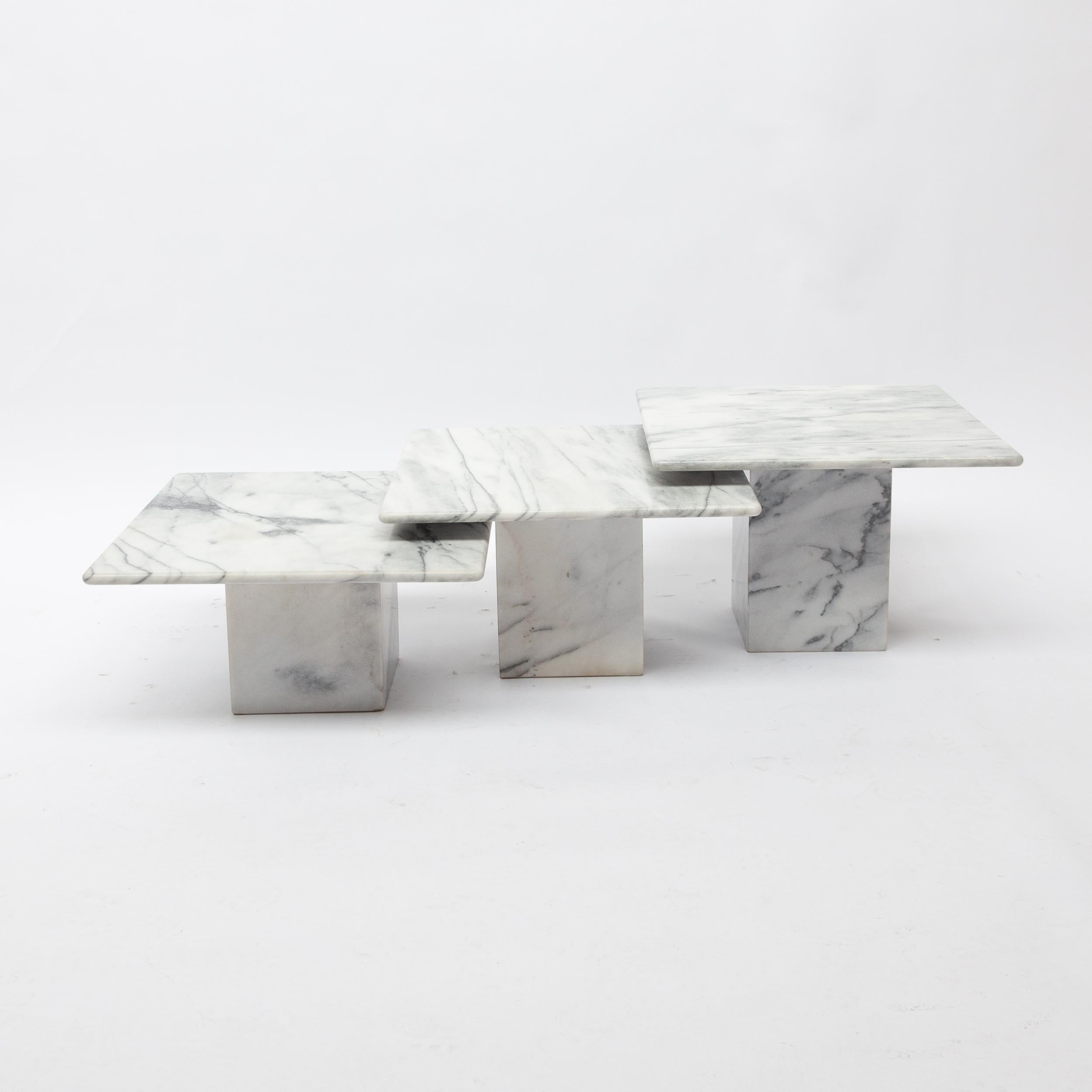 Beautiful set of three elegant coffee/side tables of three different heights in order to be put, for example, one below the other. Made in Italy in the 1970s of full marble of very elegant minimal appearance.

Measures: Table 1 60 x 60 x 40