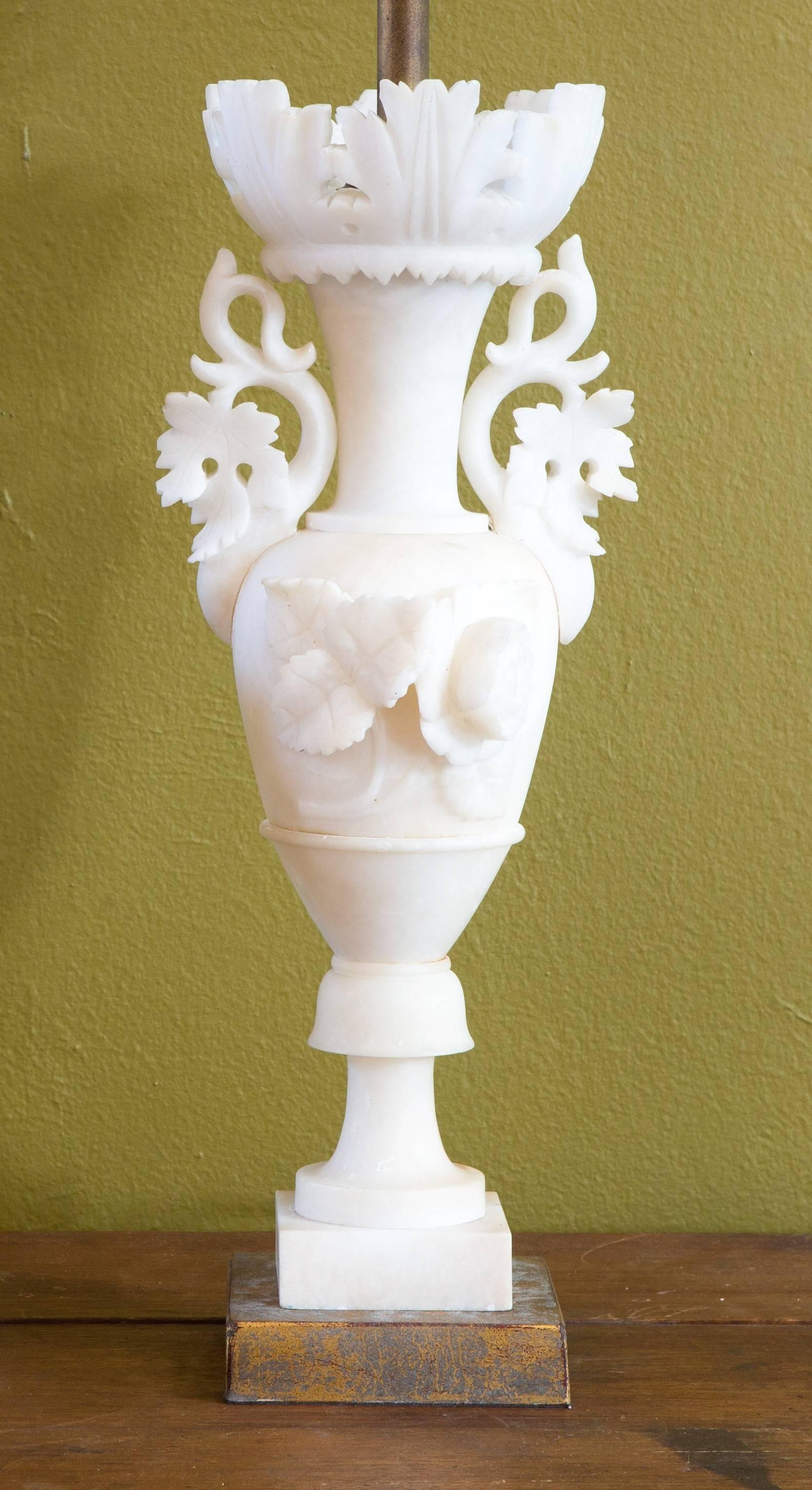 Elegant alabaster table lamp from Italy, circa 1920. Newly wired with UL listed parts. A near-pair may be available, price listed is for one table lamp.The lamps have beautiful detail and carvings.