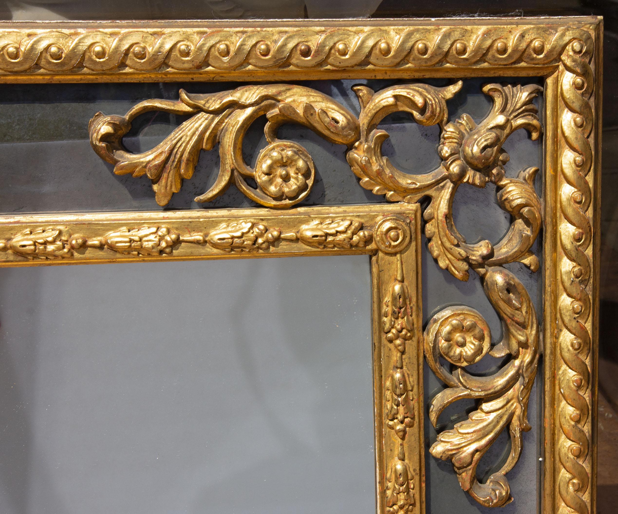 Antique carved and gilt paneled mirror. Side panels are smoked mirror glass. Great quality, early 20th century. Measures: 58.5