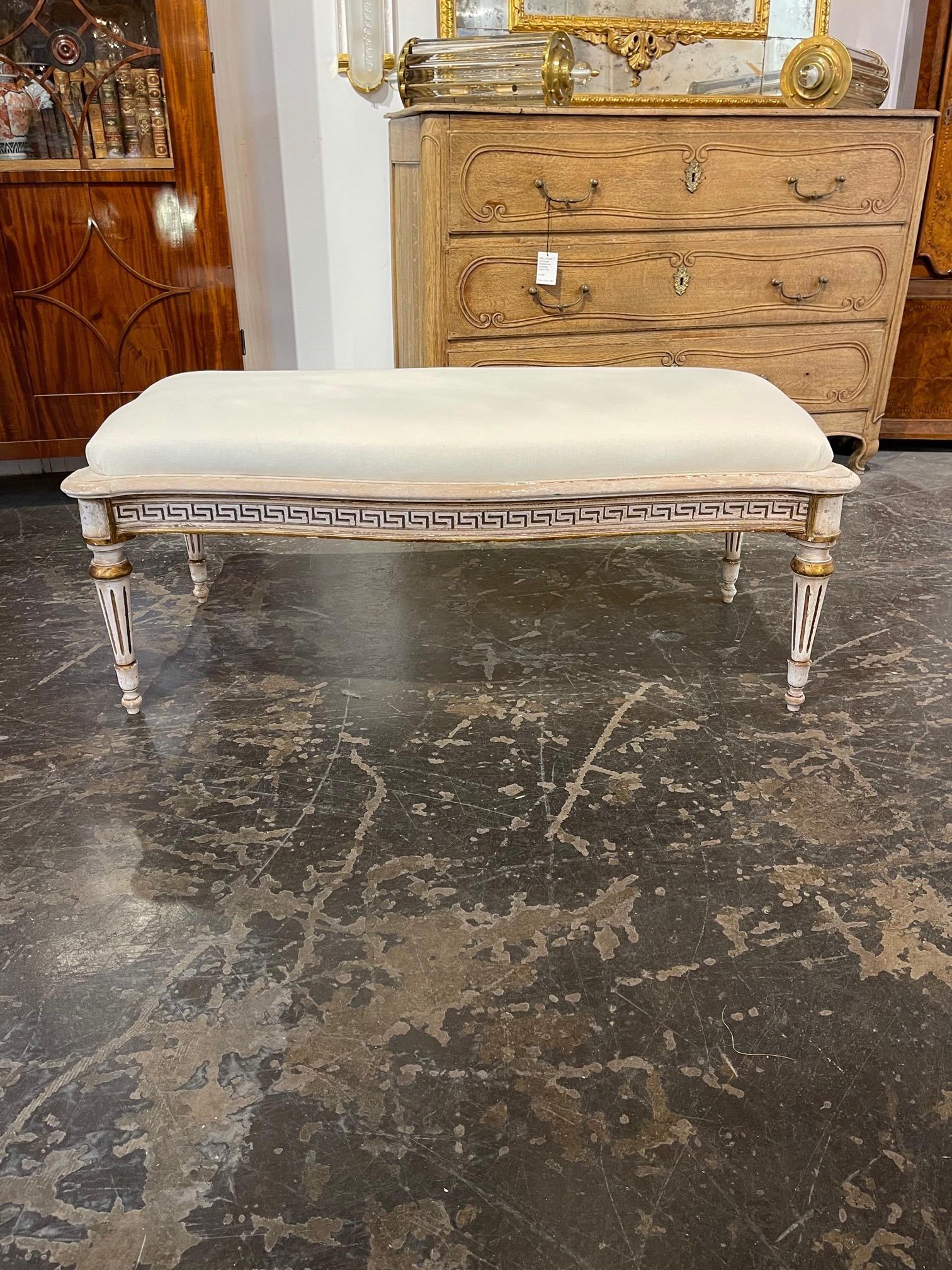 Gorgeous mid century Italian carved and painted bench with Greek key pattern. Very nice carvings and pretty creme colored upholstery. A classic piece!