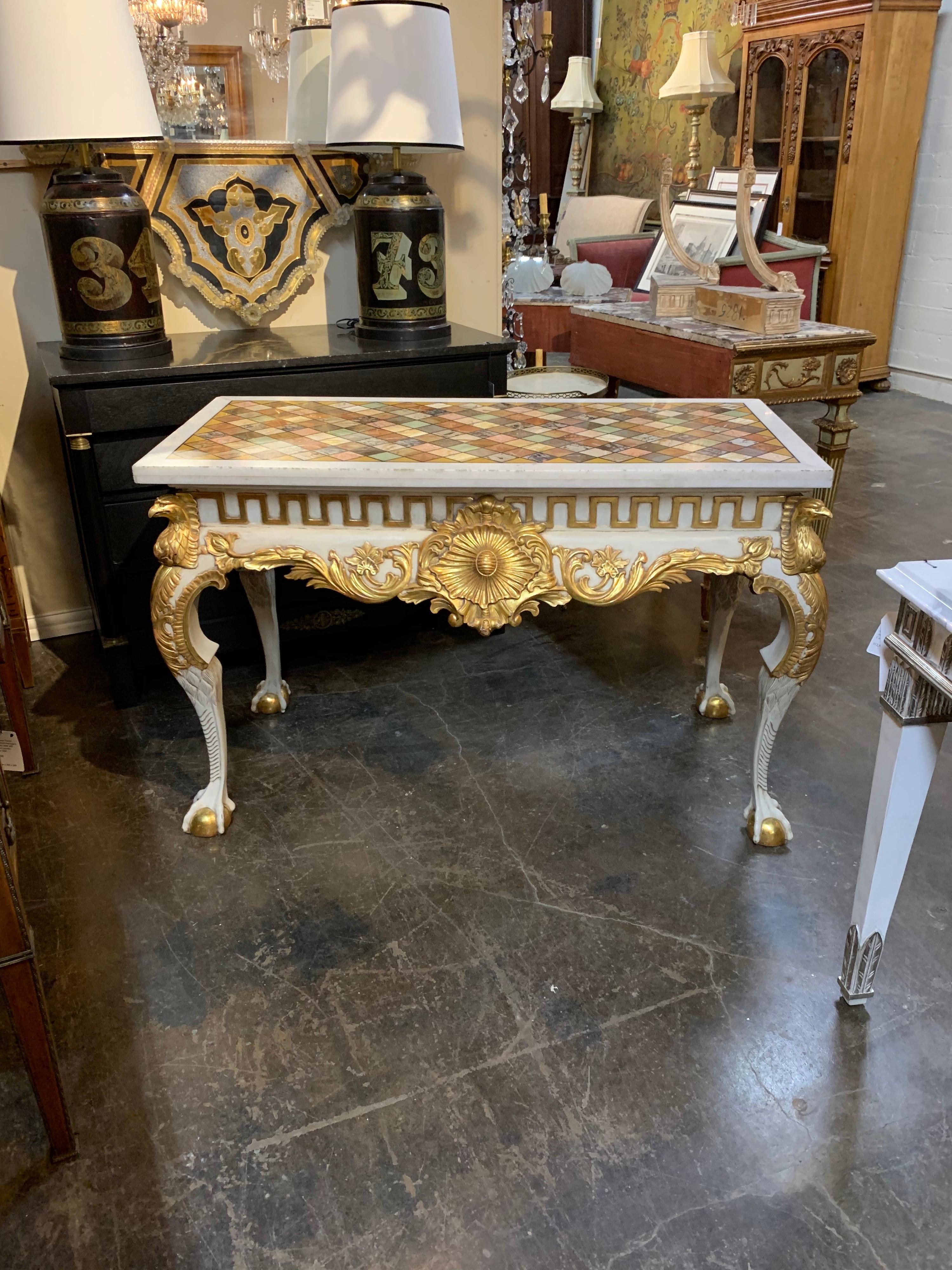Very fine Italian carved and parcel-gilt console with specimen marble top. Beautiful gilt and interesting carvings. Creates a very dramatic look!